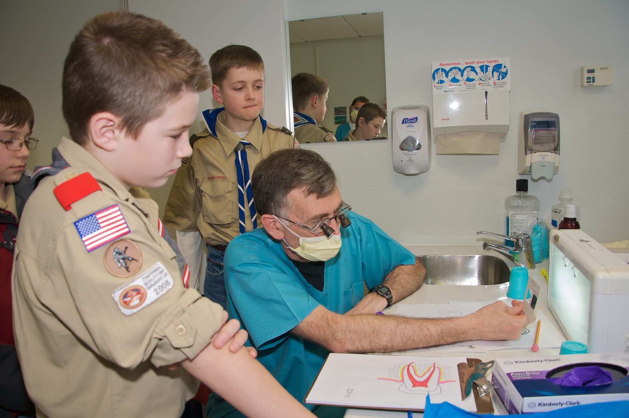 U.S. Air Force Col. Rodney Phoenix (center), 86th Dental Squadron and former Boy Scout, shows Boy Scouts from across the Kaiserslautern Military Community a dental X-ray. The 86th DS volunteered their weekend to help give the Scouts their Dentistry Merit Badge. (Courtesy photo)