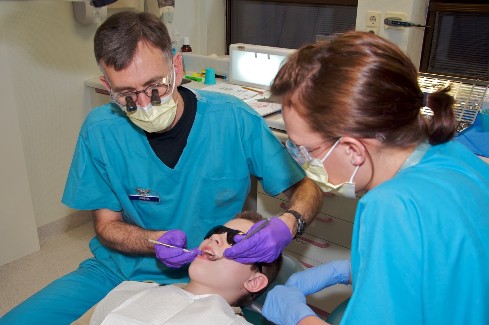 U.S. Air Force Col. Rodney Phoenix (left), 86th Dental Squadron and former Boy Scout, cleans the teeth of a Boy Scout from the Kaiserslautern Military Community area. The 86th DS volunteered their weekend to help give the Scouts their Dentistry Merit Badge. (Courtesy photo)