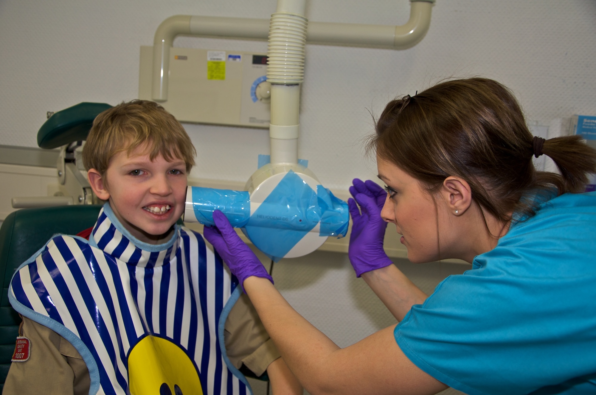 U.S. Air Force Airman 1st Class Jacqueline Grubbs (right), 86th Dental Squadron dental technician, prepares to take a dental X-ray of a Troop 69 Boy Scout. The 86th DS volunteered their weekend to help give the Scouts their Dentistry Merit Badge. (Courtesy photo)