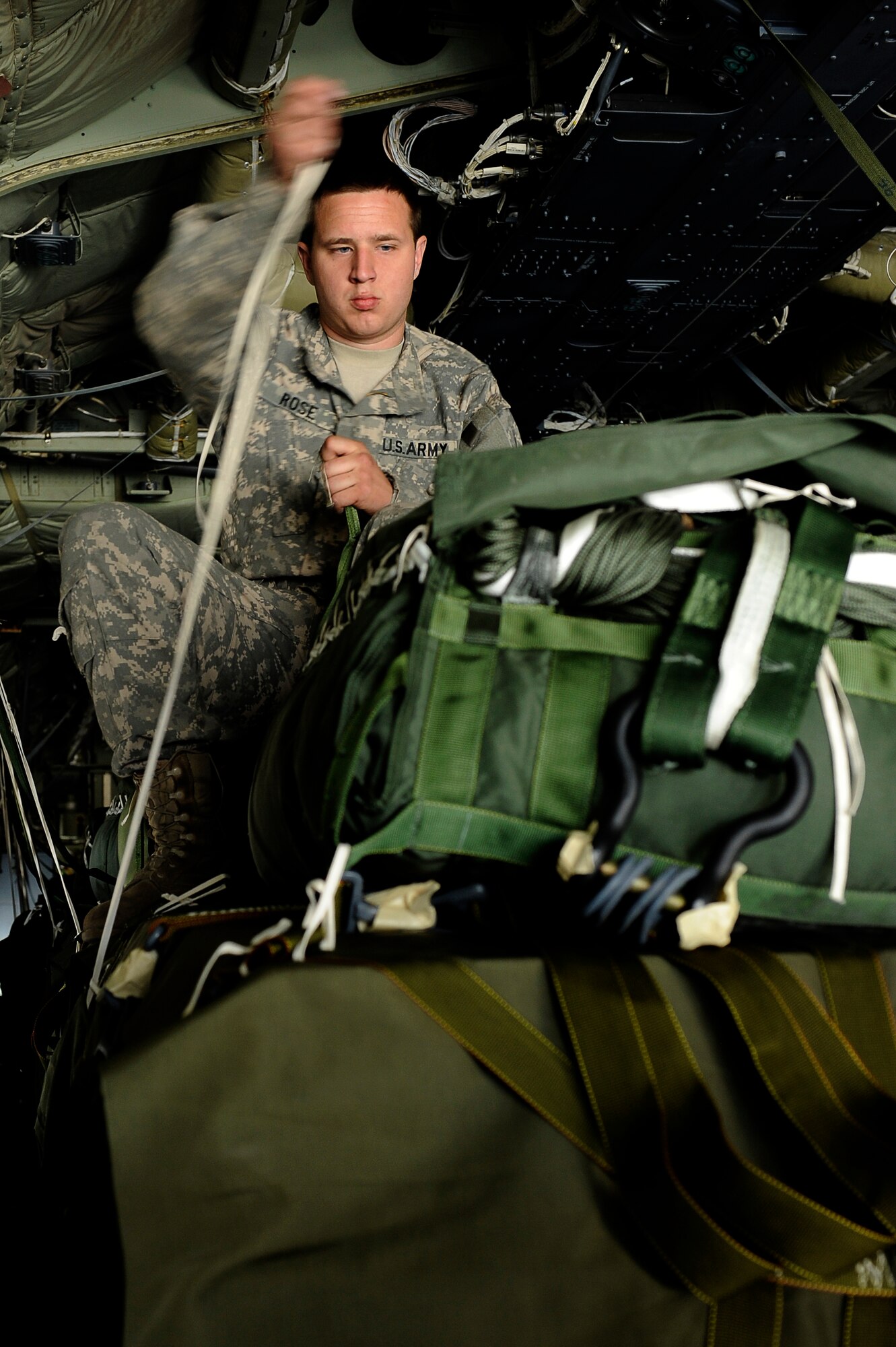 U.S. Army Jacob Rose, Combined Special Operations, prepares parachutes on cargo that was loaded into a C-130J Bagram Airfield, Afghanistan, March 2, 2010. Specialist Rose is deployed from Fort Bragg, N.C., and is from Cynphiana, Ky. (U.S. Air Force photo by/ Tech. Sgt. Jeromy K. Cross/released)





