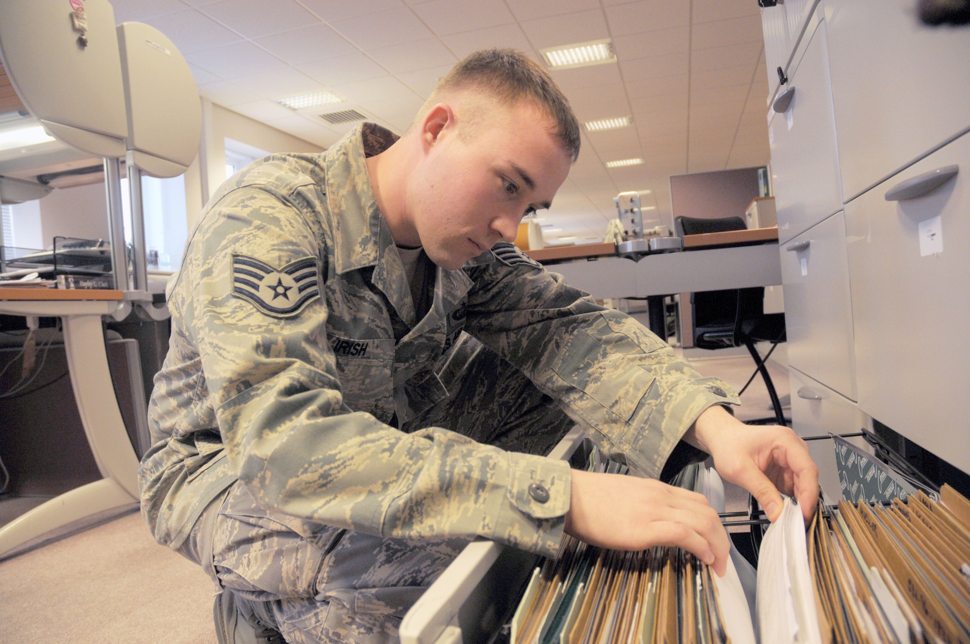 Staff Sgt. Kyle Irish, 48th Fighter Wing Comptroller Squadron NCOIC of special actions, Financial Services Flight, looks for a file record at RAF Lakenheath, England, Mar. 12. He was nominated for the Liberty Spotlight by his chain of command because he portrays the Air Force core value of "Service Before Self." (U.S. Air Force photo by Staff Sgt. Connor Estes)
