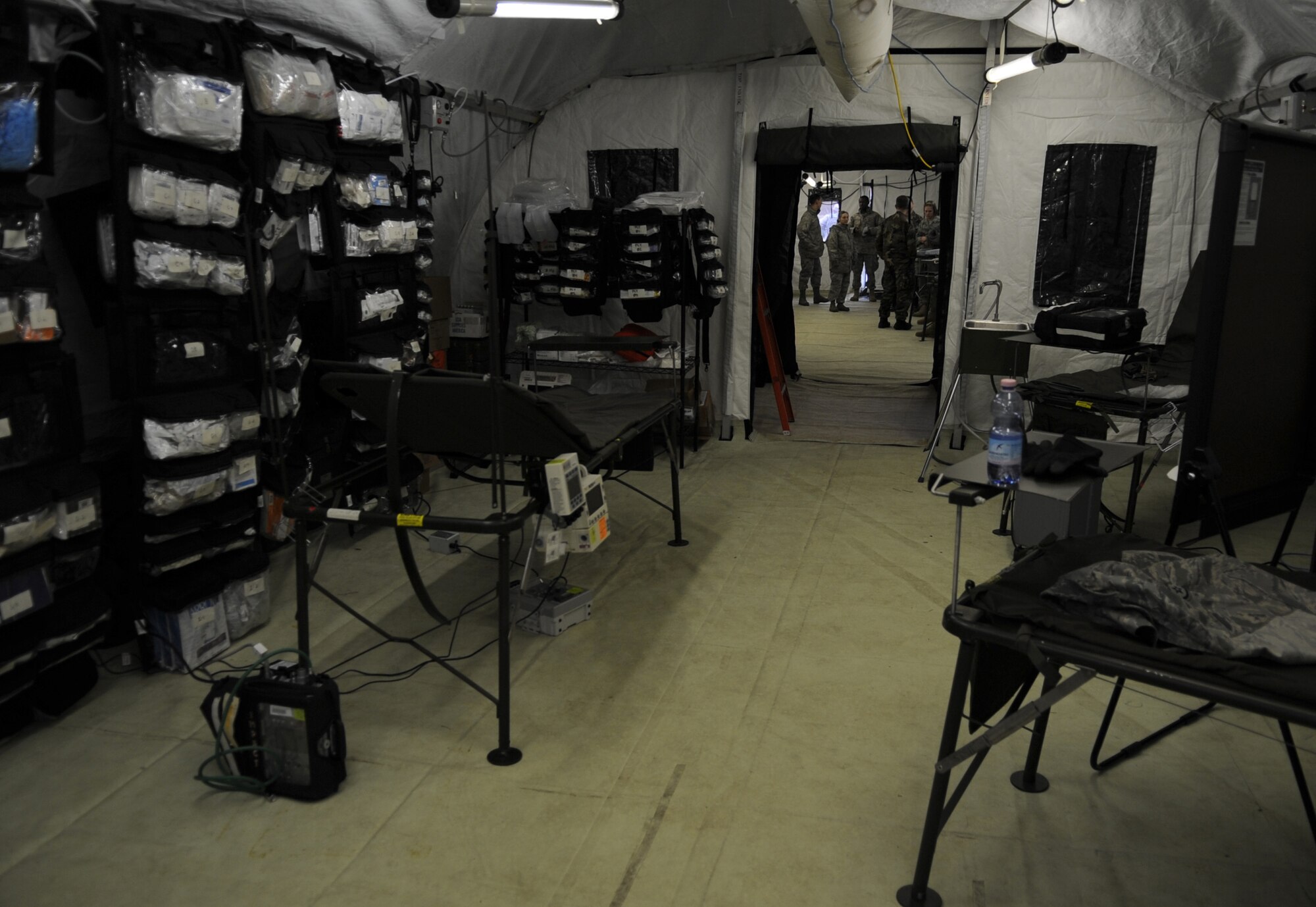 Medical supplies are made ready for use inside mobile tents during the facility population training, Ramstein Air Base, Germany, March 16, 2010. The Expeditionary Medical Support (EMEDS) Mobile Course teaches and evaluates corps specific field situations as well as offers updates in Air Force Medical Service concept of operations and doctrine. It also teaches setup and packing out of a field EMEDS compound, deployed operations, field medical, nursing and operational support equipment proficiency, field exercises to both emphasize and evaluate learning of concepts taught. (U.S. Air Force photo by Airman 1st Class Caleb Pierce)
