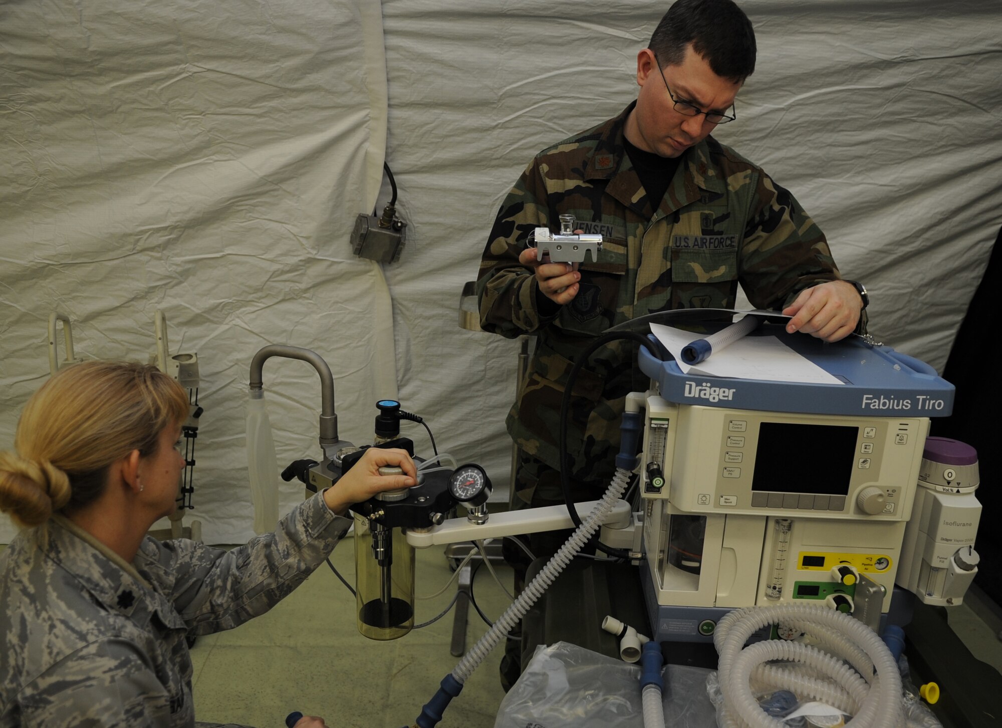 U.S. Air Force Lt. Col. Caroline Samuolis, School of Aerospace Medicine deputy division chief of contingency operations, from Brooks City-Base, Texas, and Maj. Scott Jensen, 86th Medical Dental Squadron anesthesiologist, assemble operating room medical equipment during the facility population training, Ramstein Air Base, Germany, March 16, 2010. The Expeditionary Medical Support (EMEDS) Mobile Course teaches and evaluates corps specific field situations as well as offers updates in Air Force Medical Service concept of operations and doctrine. It also teaches setup and packing out of a field EMEDS compound, deployed operations, field medical, nursing and operational support equipment proficiency, field exercises to both emphasize and evaluate learning of concepts taught. (U.S. Air Force photo by Airman 1st Class Caleb Pierce)