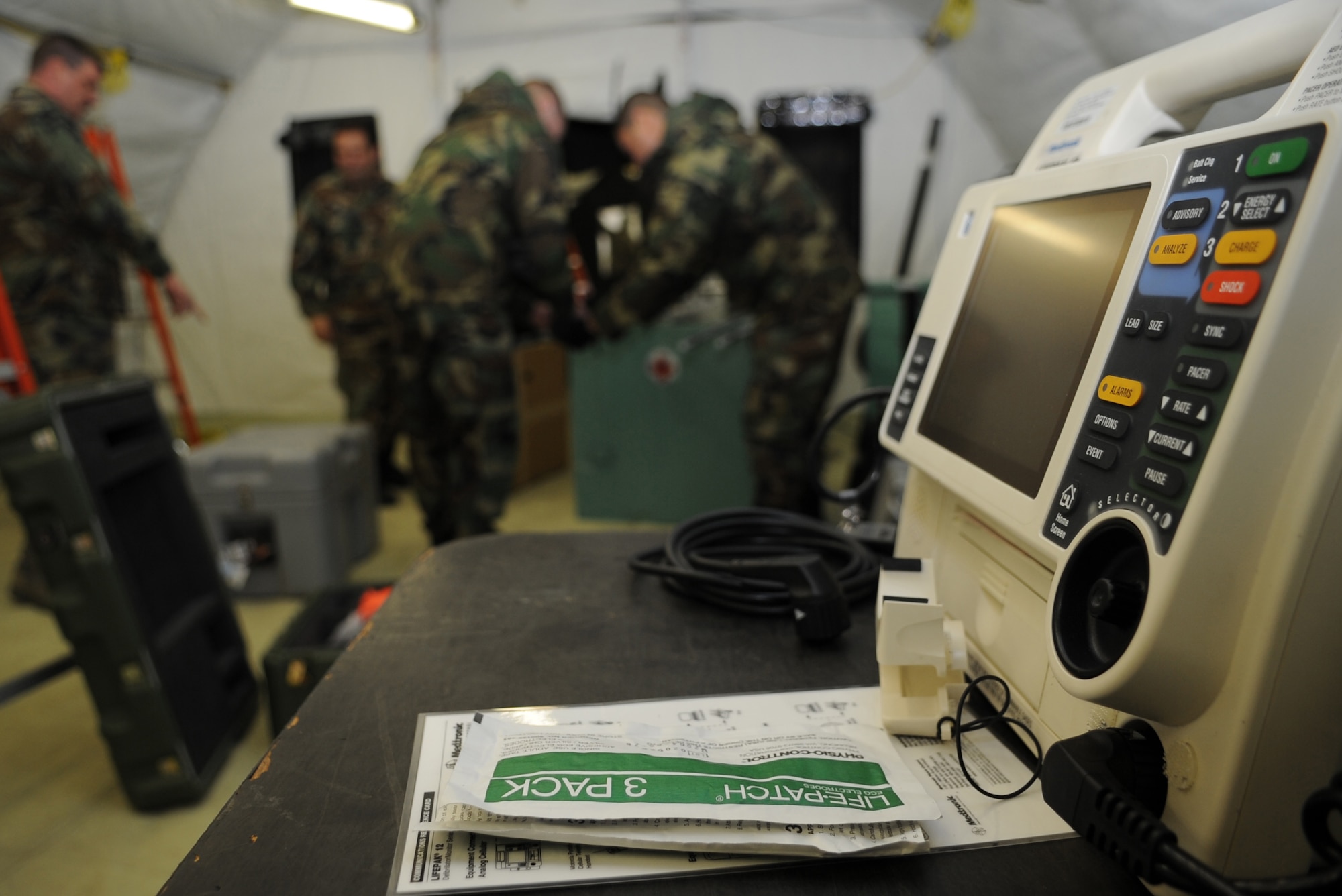 U.S. Air Force medical members participating in the Expeditionary Medical Support (EMEDS) Mobile Course facilitate medical equipment into the mobile tents needed for mission readiness during the facility population training, Ramstein Air Base, Germany, March 16, 2010. The EMEDS course teaches and evaluates corps specific field situations as well as offers updates in Air Force Medical Service concept of operations and doctrine. It also teaches setup and packing out of a field EMEDS compound, deployed operations, field medical, nursing and operational support equipment proficiency, field exercises to both emphasize and evaluate learning of concepts taught. (U.S. Air Force photo by Airman 1st Class Caleb Pierce)