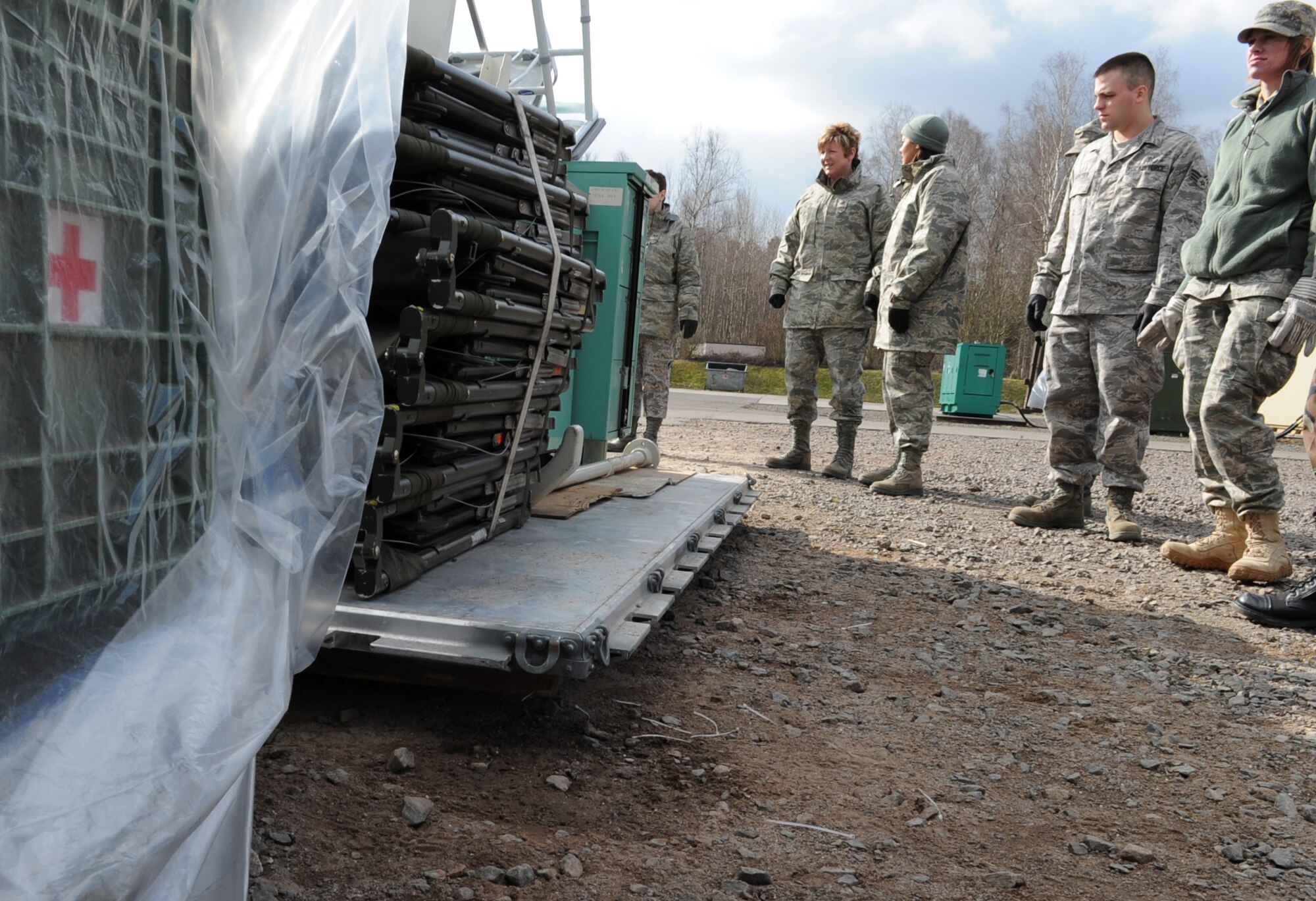 U.S. Air Force medical members participating in the Expeditionary Medical Support (EMEDS) Mobile Course facilitate medical equipment into mobile tents needed for mission readiness during the facility population training, Ramstein Air Base, Germany, March 16, 2010. The EMEDS course teaches and evaluates corps specific field situations as well as offers updates in Air Force Medical Service concept of operations and doctrine. It also teaches setup and packing out of a field EMEDS compound, deployed operations, field medical, nursing and operational support equipment proficiency, field exercises to both emphasize and evaluate learning of concepts taught. (U.S. Air Force photo by Airman 1st Class Caleb Pierce) 