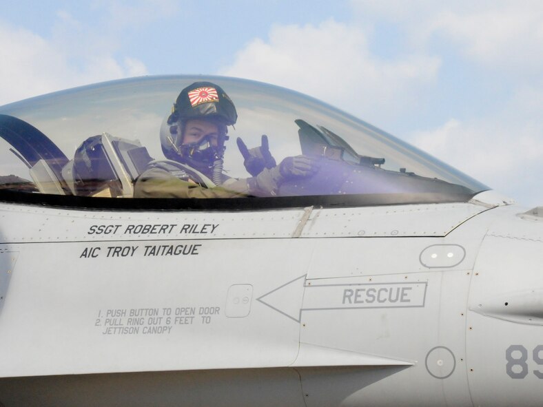 TSUIKI AIR BASE, Japan -- Capt. Ryan Cross, 14th Fighter Squadron pilot, flashes the samurai symbol as he taxis down the runway for takeoff March 11. During the aviation training relocation exercise F-16 Fighting Falcon pilots from Misawa flew dissimilar air combat missions against Japan Air Self-Defense Force F-2s and F-15s. (U.S. Air Force photo/Staff Sgt. Rachel Martinez)
