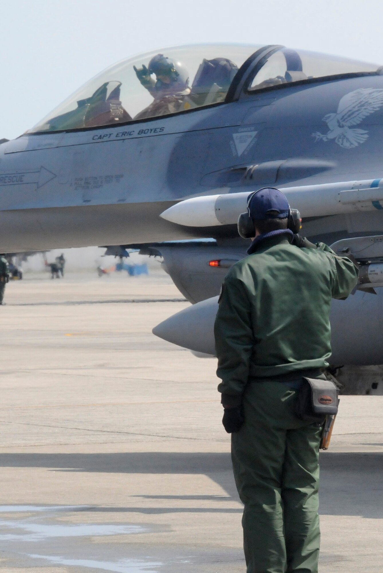 TSUIKI AIR BASE, Japan -- Japan Air Self-Defense Force Staff Sgt. Yuuta Isoya, an F-15 crewchief, salutes Capt. Matt Kenkel, 14th Fighter Squadron pilot, as he taxis out during an aviation training relocation exercise March 11. ATR exercises are designed to operational readiness and bilateral interoperability for U.S. and Japanese forces. (U.S. Air Force photo/Staff Sgt. Rachel Martinez)