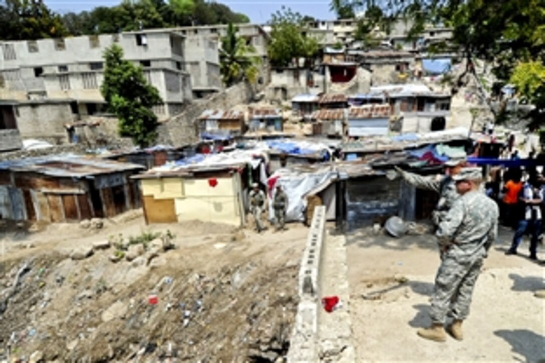 U.S. Army Lt. Col. David Doyle, left, commanding officer of the 82nd Airborne Division's 2nd Battalion, 325th Airborne Infantry Regiment, briefs Lt. Gen. Ken Keen, commanding general of Joint Task Force Haiti, on the camps for displaced residents in his area of responsibility in Port-Au-Prince, Haiti, March 16, 2010.