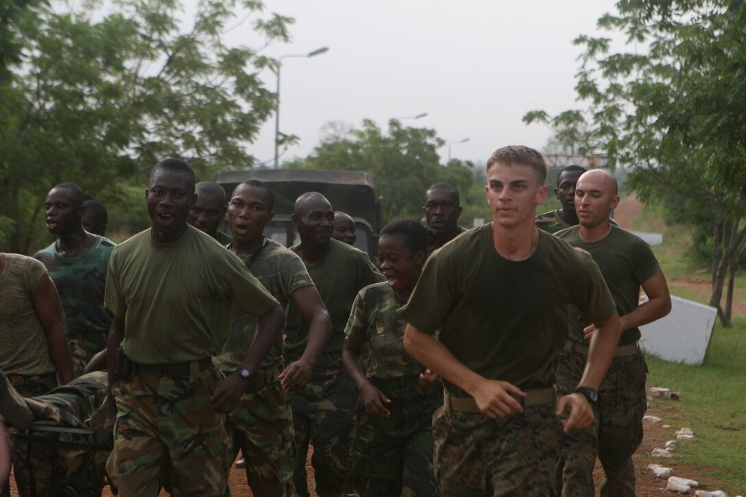 Marines with the Security Cooperation Marine Air Ground Task Force, Africa Partnership Station 10, and Ghanaian military personnel participate in a morning of physical training, March 17.  Marines and Ghanaians are participating in military-to-military familiarization events for 3 weeks with a focus on security, stability and humanitarian assistance.