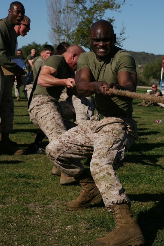 Sgt. Karlson J. Philip, 25, from New York, combat engineer, Headquarters and Service Company, 7th Engineer Support Battalion, 1st Marine Logistics Group, works with his fellow Marines in winning a tug-a-war match at the St. Patrick’s Day Field Meet at Lake O’Neil, here March 17.