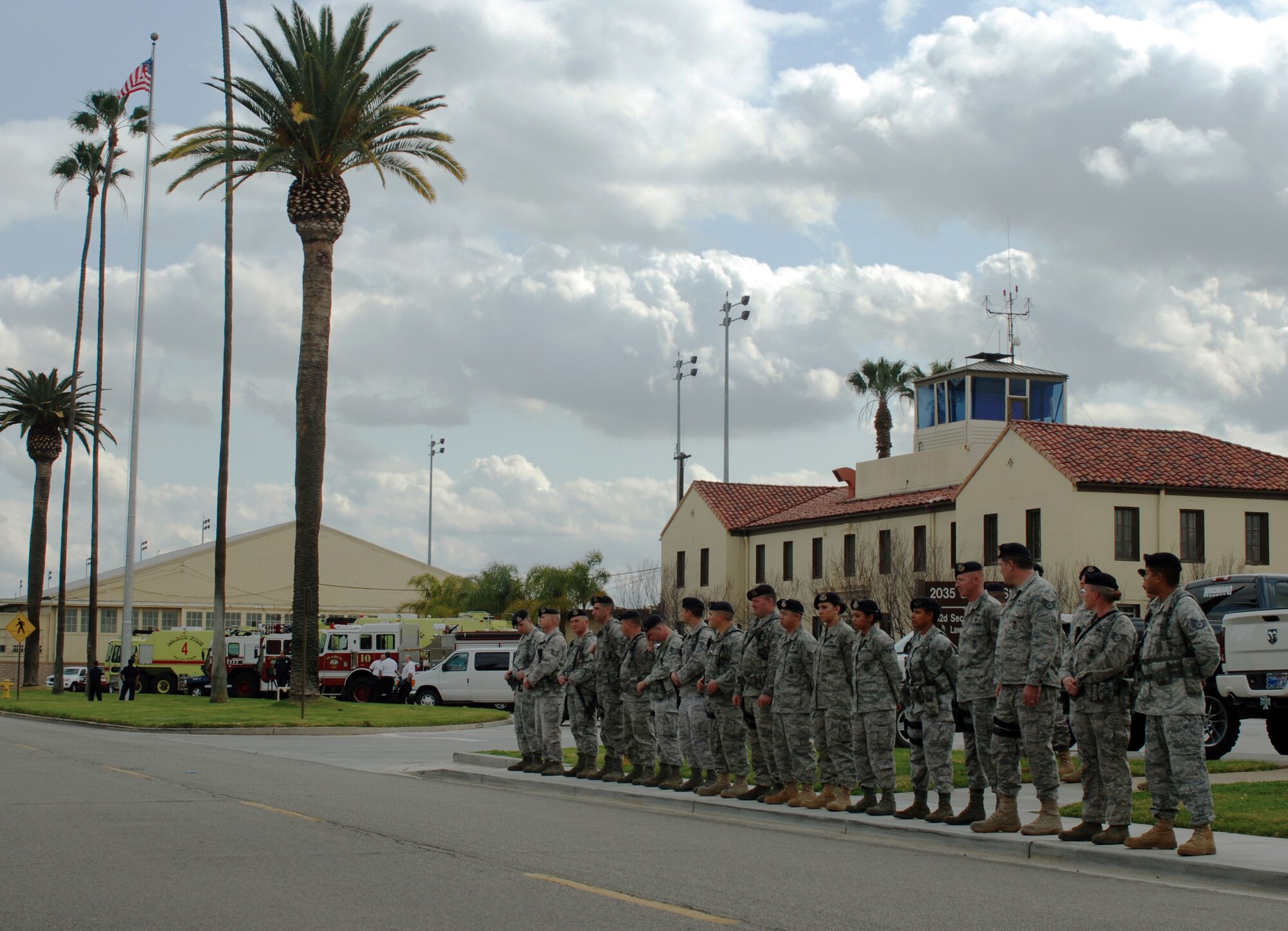 Team March members flooded Graeber Street to await the passing of the remains of Army Staff Sgt. Michael David P. Cardenaz of Corona, Calif., who was killed by a rocket propelled grenade while serving in Afghanistan. Sergeant Cardenaz’s family was on base to meet the plane carrying his remains. As the hearse passed, service members saluted and civilians placed their hands over their hearts. The Fire Department turned on their fire engines’ emergency lights. The family members in the long procession cried as they observed the support of the members of Team March paying respect to a Soldier they had likely never known. (U.S. Air Force photo by Megan Just)