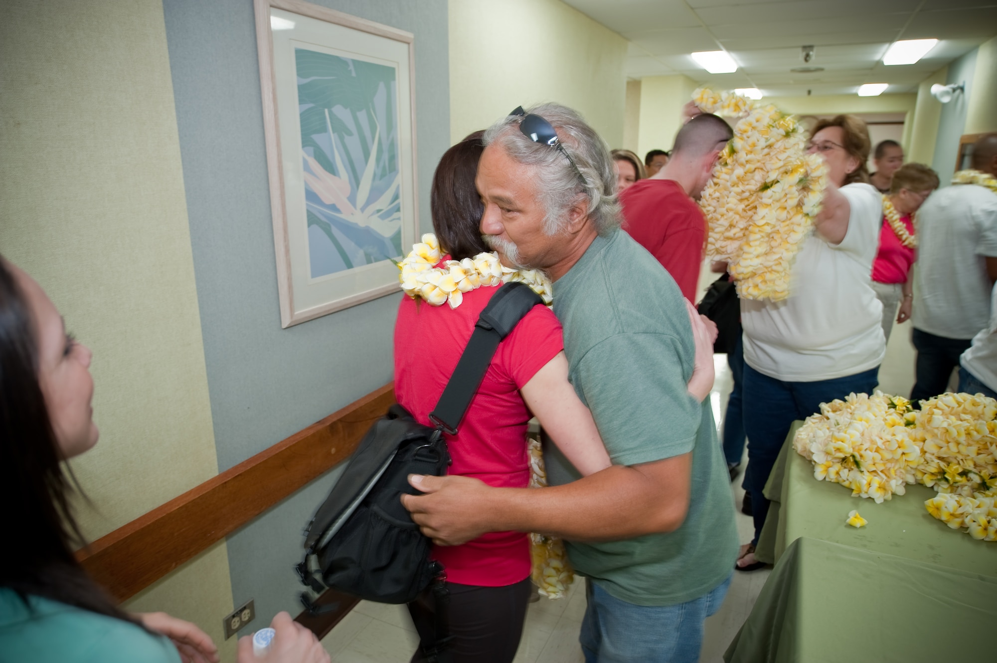 Colorado Air National Guard personnel of the 140th Medical Group, Buckley Air Force Base are greeted with a lei and a hug by Rodney and Denise, staff of the Kahuku Medical Center, Kahuku, Hawaii, March 14, 2010.  More than 60 Guardsmen attended a familiarization briefing to learn about the various aspects of the Hawaiian culture before beginning their work as part of E Malama Kakou (translated from Hawaiian as “to care for all”), an Innovative Readiness Training Program. (U.S. Air Force photo/Master Sgt. John Nimmo, Sr.) (RELEASED)