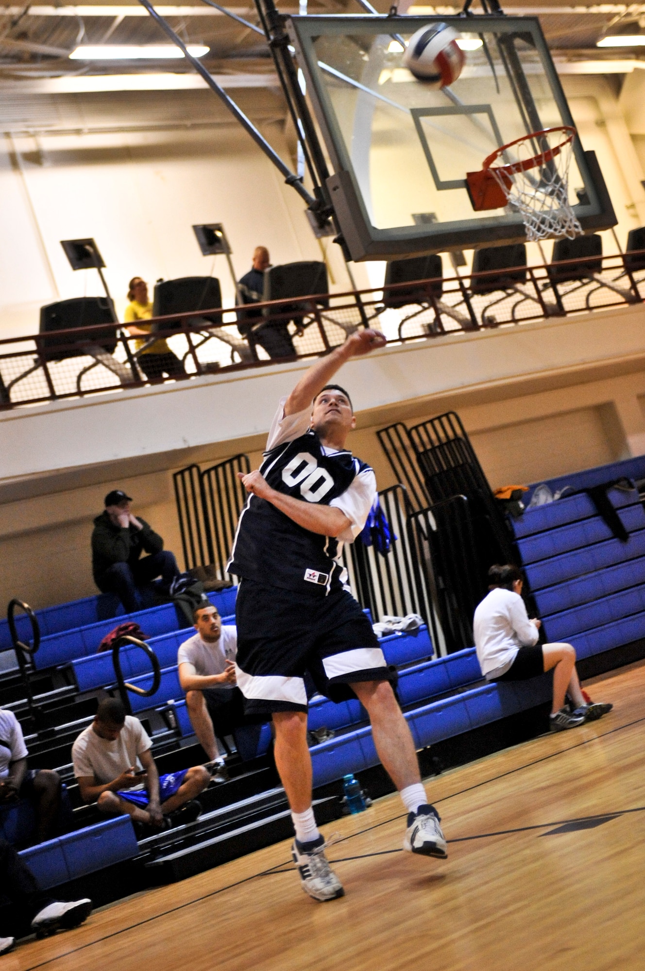 ELMENDORF AIR FORCE BASE, Alaska – Timothy Riddle, 3rd Civil Engineer Squadron, serves the ball to members of the 3rd Operations Support Squadron during a game of intramural volleyball March 17. The 3rd CES won the match by winning two out of three sets. (Air Force photo by Airman 1st Class Christopher Gross)