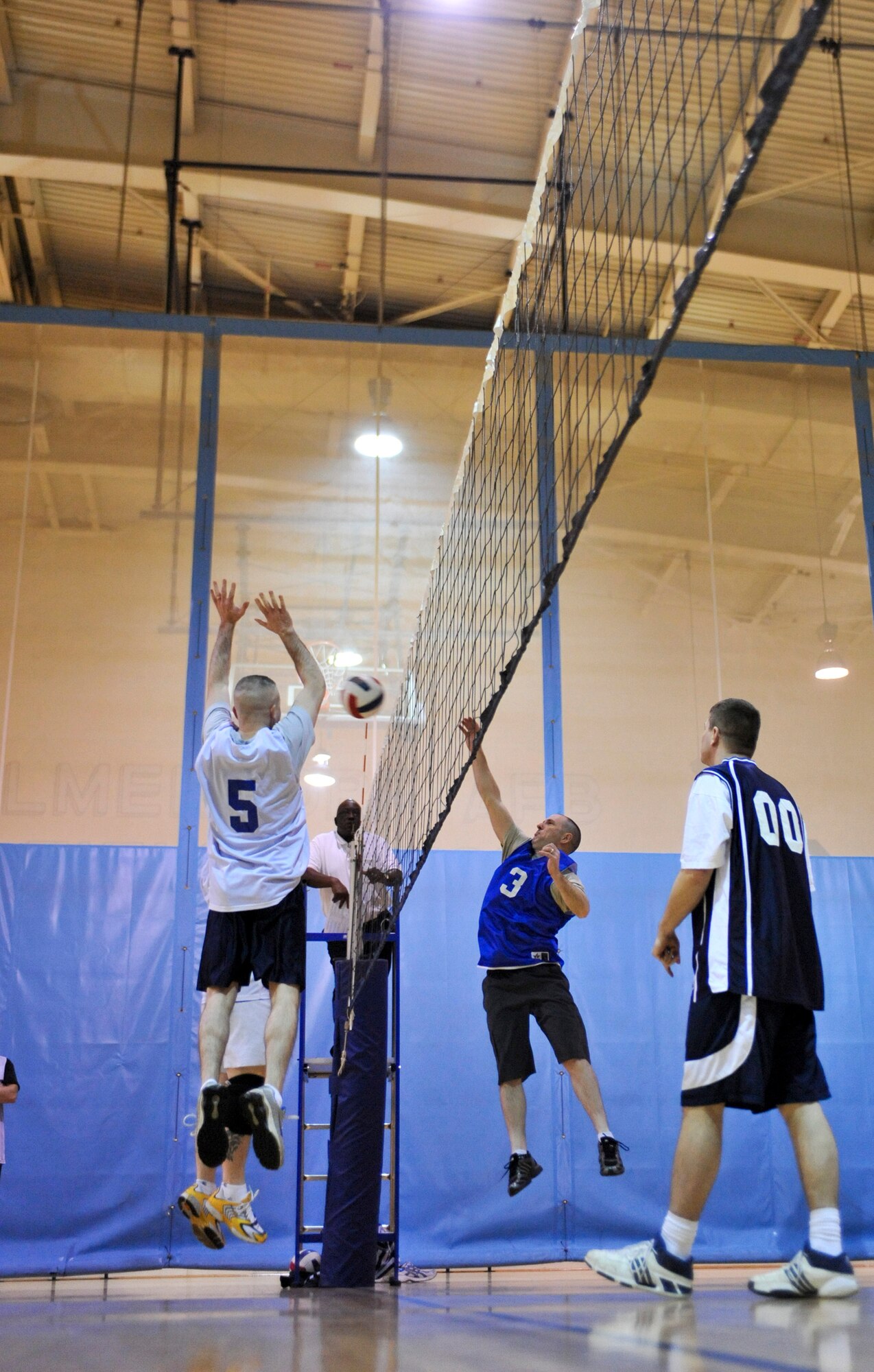 ELMENDORF AIR FORCE BASE, Alaska – Timothy Coulman, 3rd Civil Engineer Squadron (blue), spikes the ball over the net as Matthew Johnston, 3rd Operations Support Squadron, attempts to block it during a game of intramural volleyball March 17. The 3rd CES won the match by winning two out of three sets. (Air Force photo by Airman 1st Class Christopher Gross)