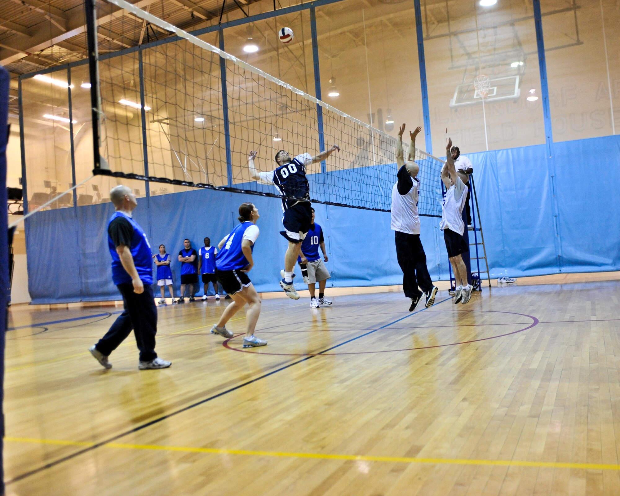 ELMENDORF AIR FORCE BASE, Alaska – Timothy Riddle, 3rd Civil Engineer Squadron (blue), prepares to spike the ball against the 3rd Operations Support Squadron during a game of intramural volleyball March 17. The 3rd CES won the match by winning two out of three sets. (Air Force photo by Airman 1st Class Christopher Gross)
