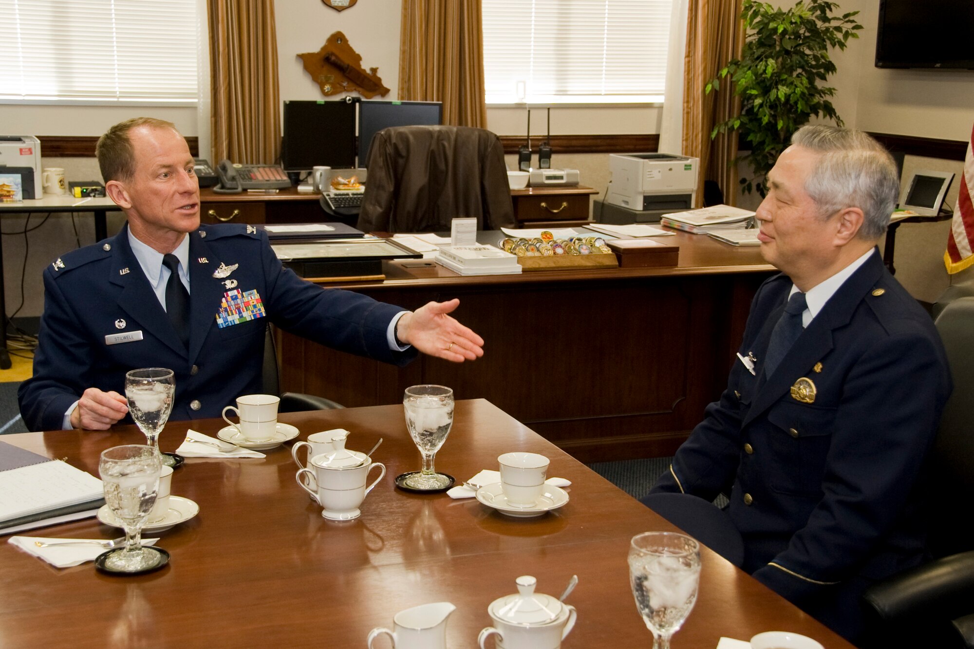 MISAWA AIR BASE, Japan -- Col. David Stilwell, 35th Fighter Wing commander, and Takashi Ishizuka, chief of Misawa Police Station, share stories during an office call March 17 at the wing headquarters building. During the office call, Colonel Stilwell and Mr. Ishizuka also thanked each other for their support and cooperation in sustaining the relationship between Misawa Air Base and the Misawa Police Station. (U.S. Air Force photo/Senior Airman Jamal D. Sutter)