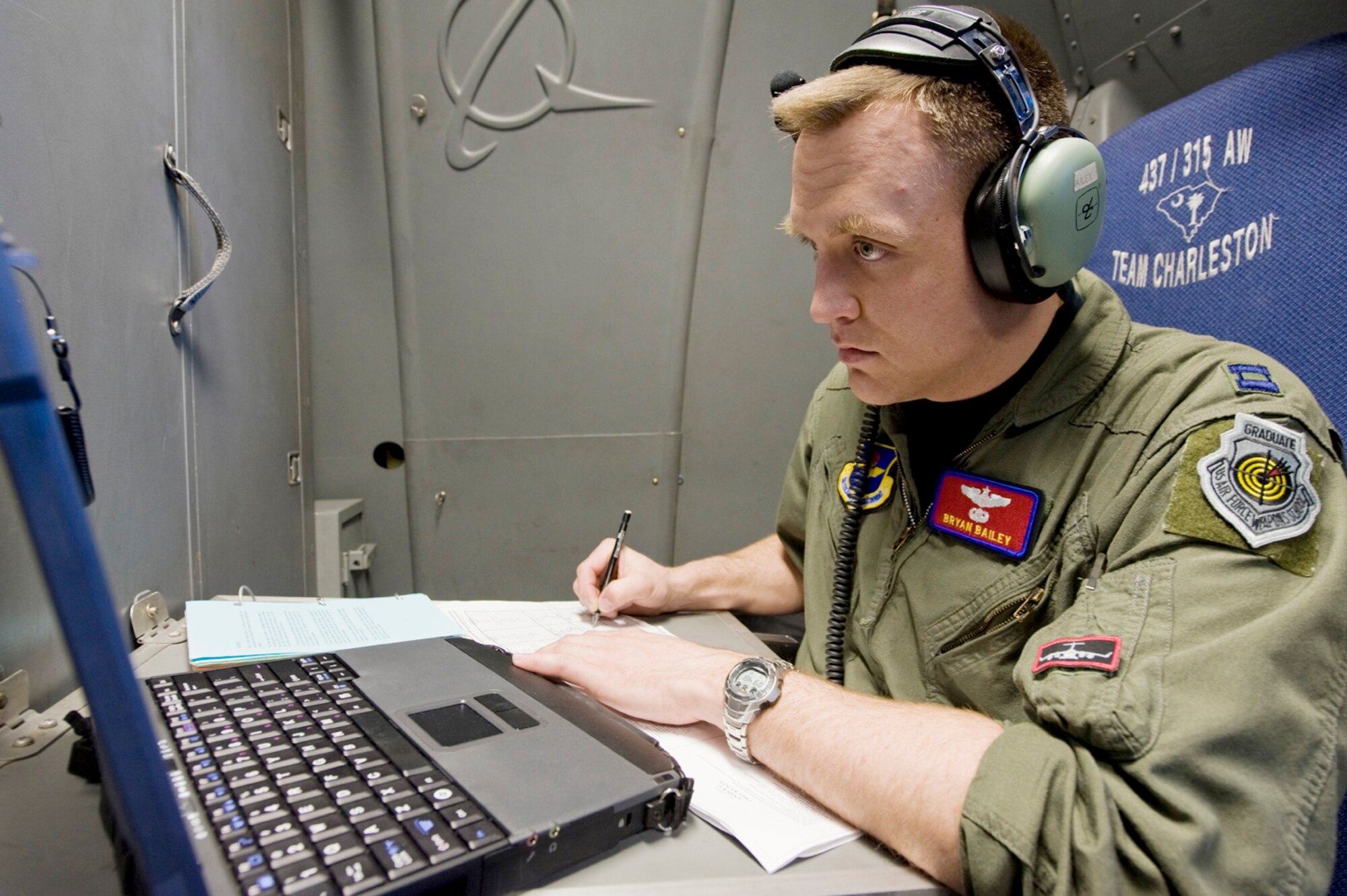 Capt. Bryan Bailey uses an on board computer to translate information received from a drop sonde into coordinates for a precision air drop March 18, 2010, at Altus Air Force Base, Okla. Captain Bailey is a weapons officer with the 58th Airlift Squadron.(U.S. Air Force Photo/Master Sgt. Jack Braden)