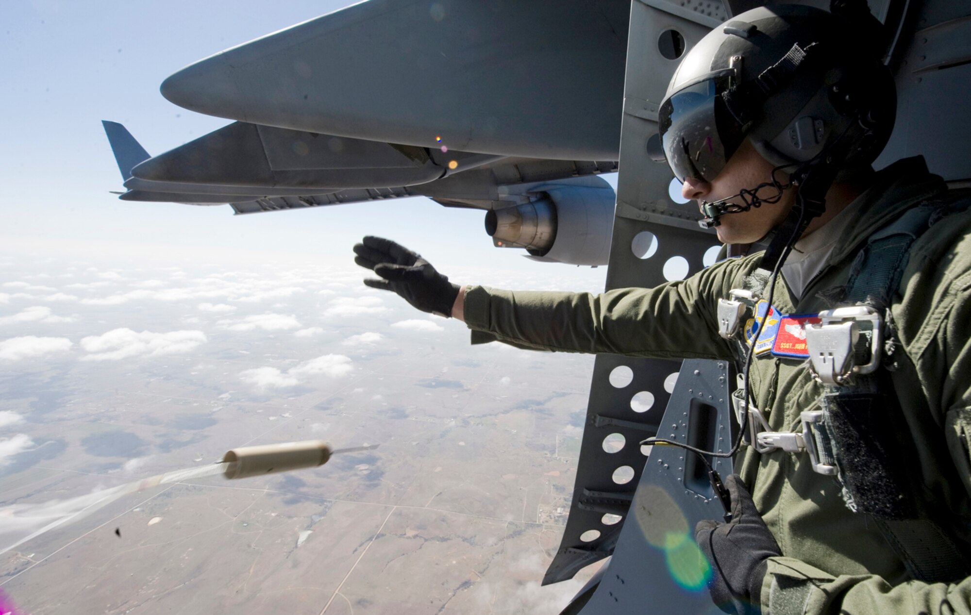 Staff Sgt. John Frisk releases a drop sonde March 18, 2010, at Altus Air Force Base, Okla. Sergeant Frisk is a C-17 Globemaster III loadmaster with the 58th Airlift Squadron.(U.S. Air Force Photo/Master Sgt. Jack Braden)