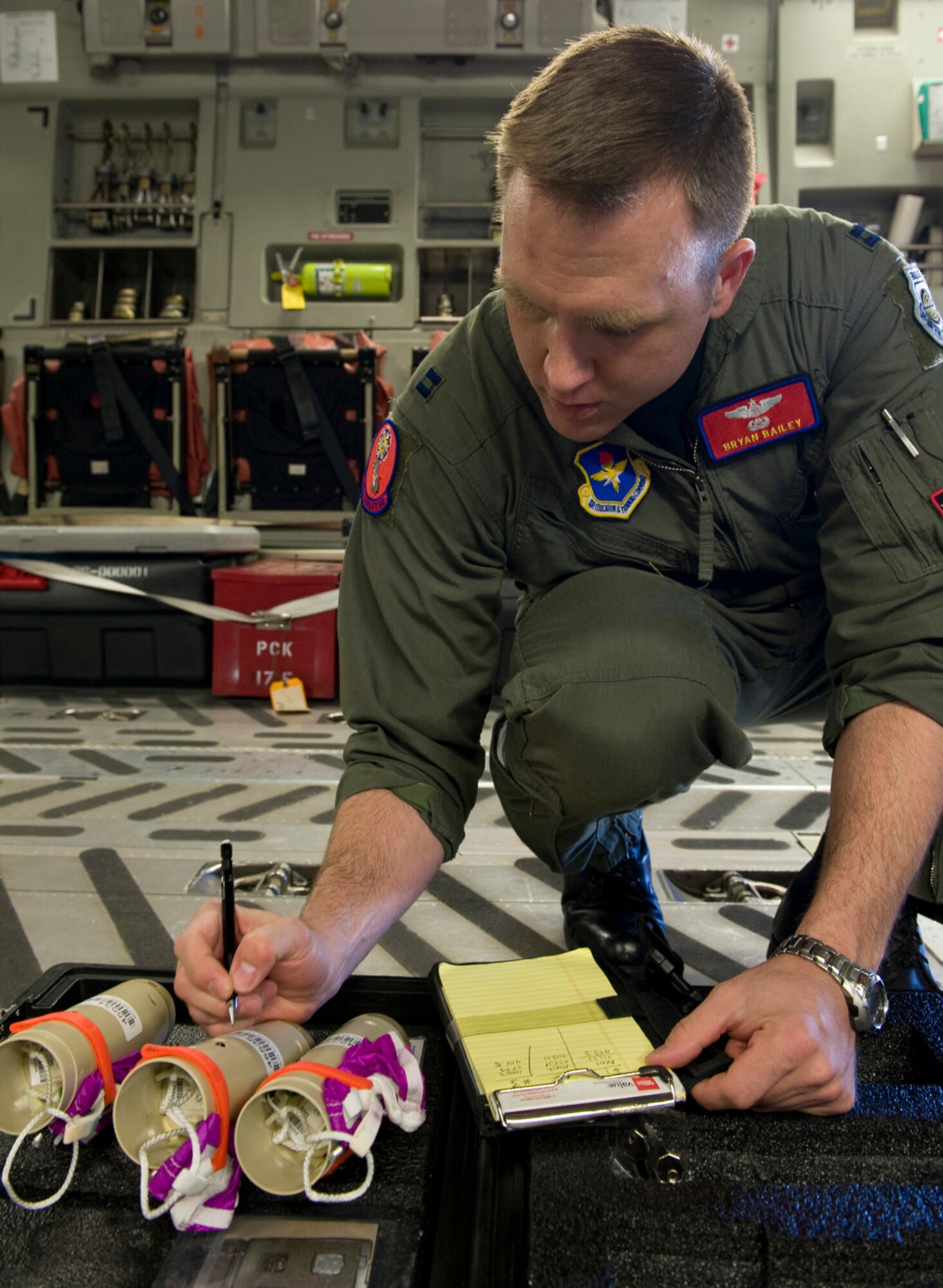 Capt. Bryan Bailey verifies serial numbers and frequencies on drop sondes March 18, 2010, at Altus Air Force Base, Okla. Captain Bailey is a weapons officer with the 58th Airlift Squadron. (U.S. Air Force Photo/Master Sgt. Jack Braden)