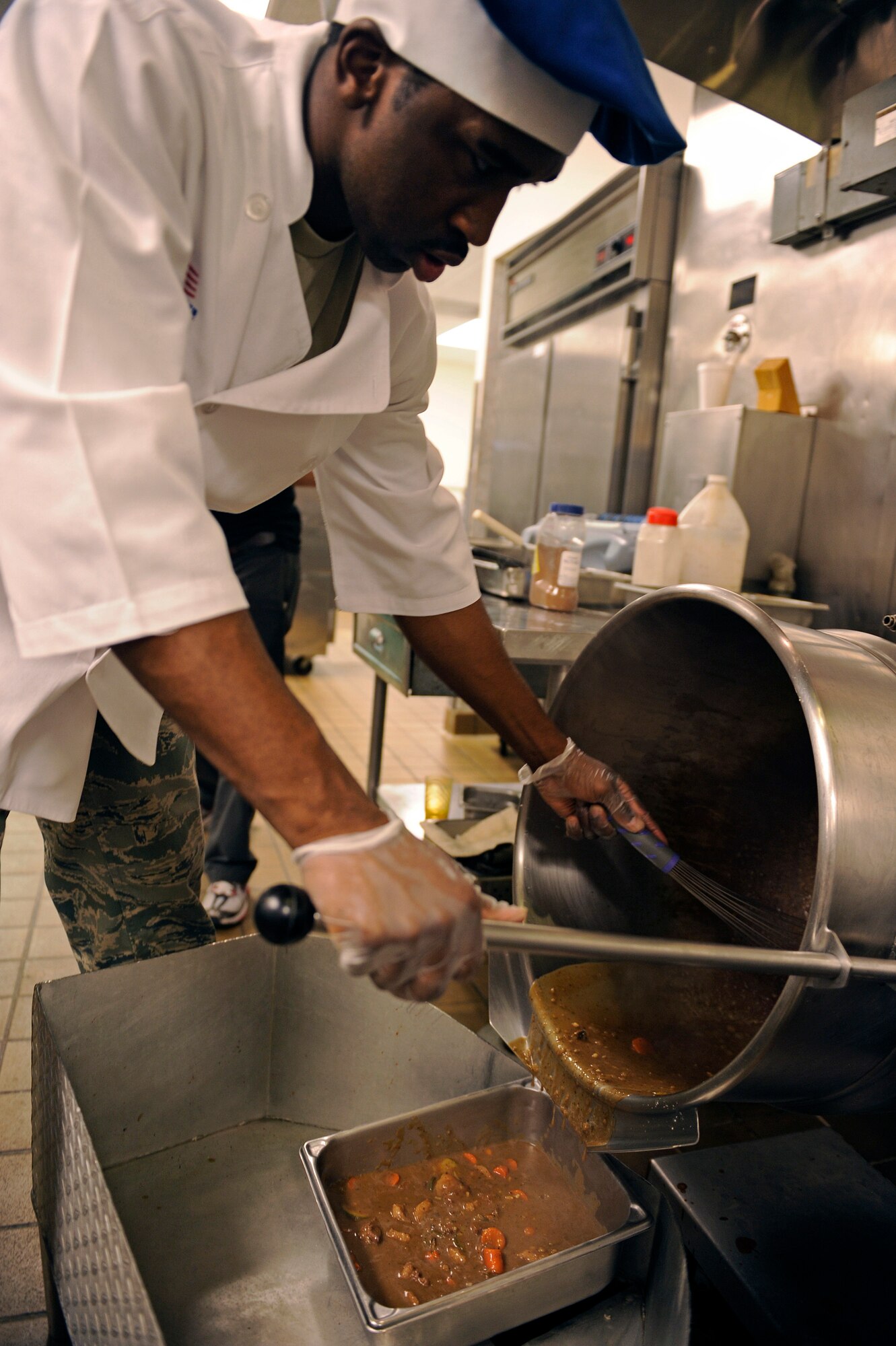 ELLSWORTH AIR FORCE BASE, S.D. -- Airman 1st Class Desmond Boone, 28th Force Support Squadron food services technician, prepares an entrée during the second annual Ellsworth Iron Chef competition, March 17.  The teams had one hour to create an appetizer, entrée and dessert. (U.S. Air Force photo/Senior Airman Marc I. Lane)