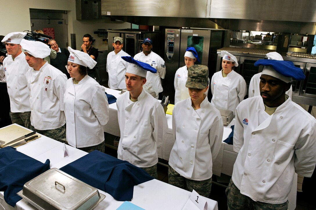 ELLSWORTH AIR FORCE BASE, S.D. -- Four, three-person, teams stand ready to begin the second annual Ellsworth Iron Chef competition, March 17.  The teams had one hour to prepare three dishes using corned beef, milk-fish, cabbage, peppers, mushrooms, fruits, parsnips, turnips and onions into an appetizer, entrée and dessert. (U.S. Air Force photo/Senior Airman Marc I. Lane)