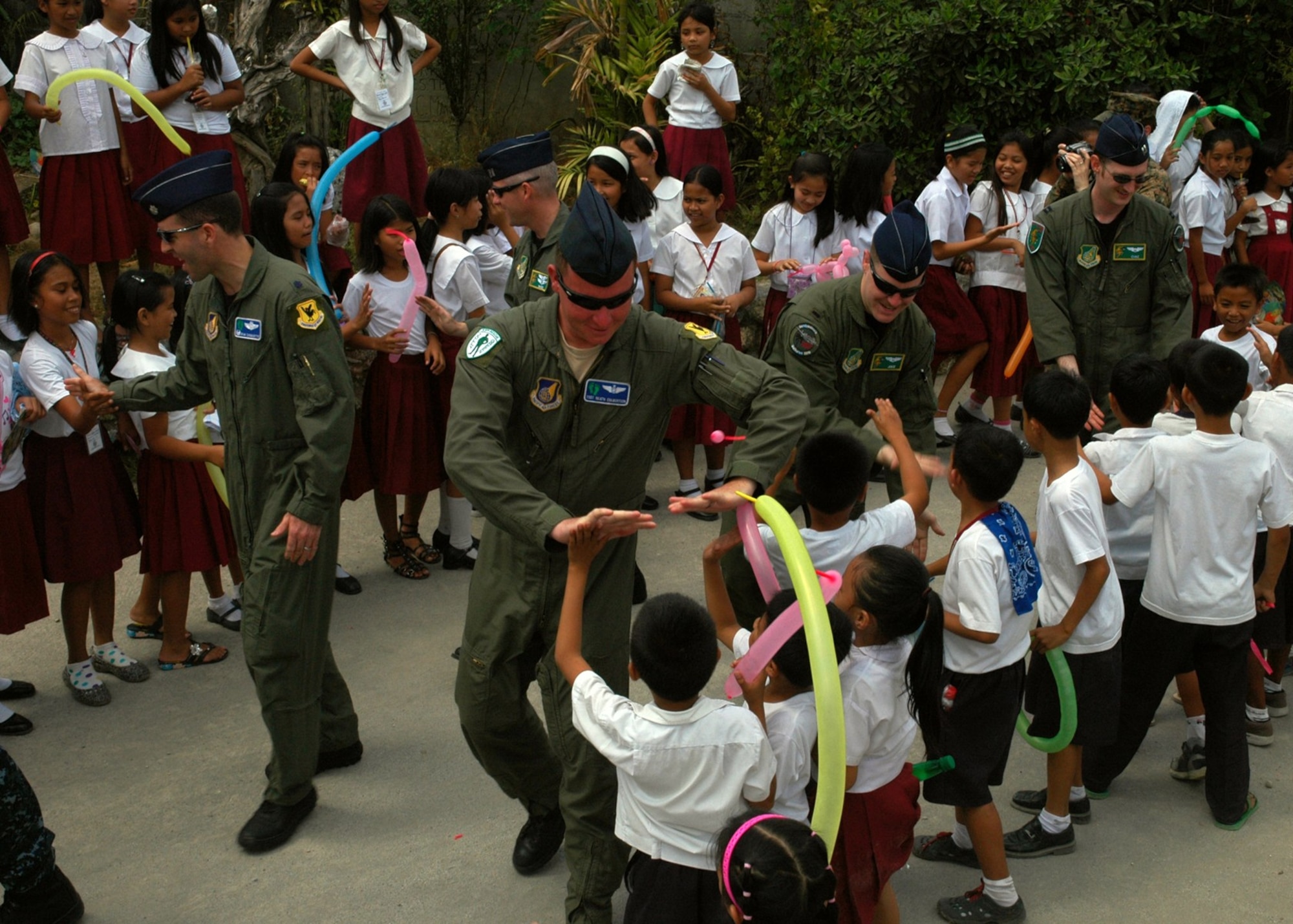 Students at Sapang Bato Elementary School in Angeles City, Philippines, greet U.S. Air Force guests during a community relations visit to the school March 15, 2010.  Military members from the U.S. military and the Armed Forces of the Philippines visited the school to distribute clothing, hygiene products and toys to the 1,700 students in the area during Balikatan 2010. Balikatan is an annual bilateral exercise involving the Philippine military, Philippine civil defense agencies and the U.S. military. (U.S. Navy photo/Chief Petty Officer David M. Votroubek)