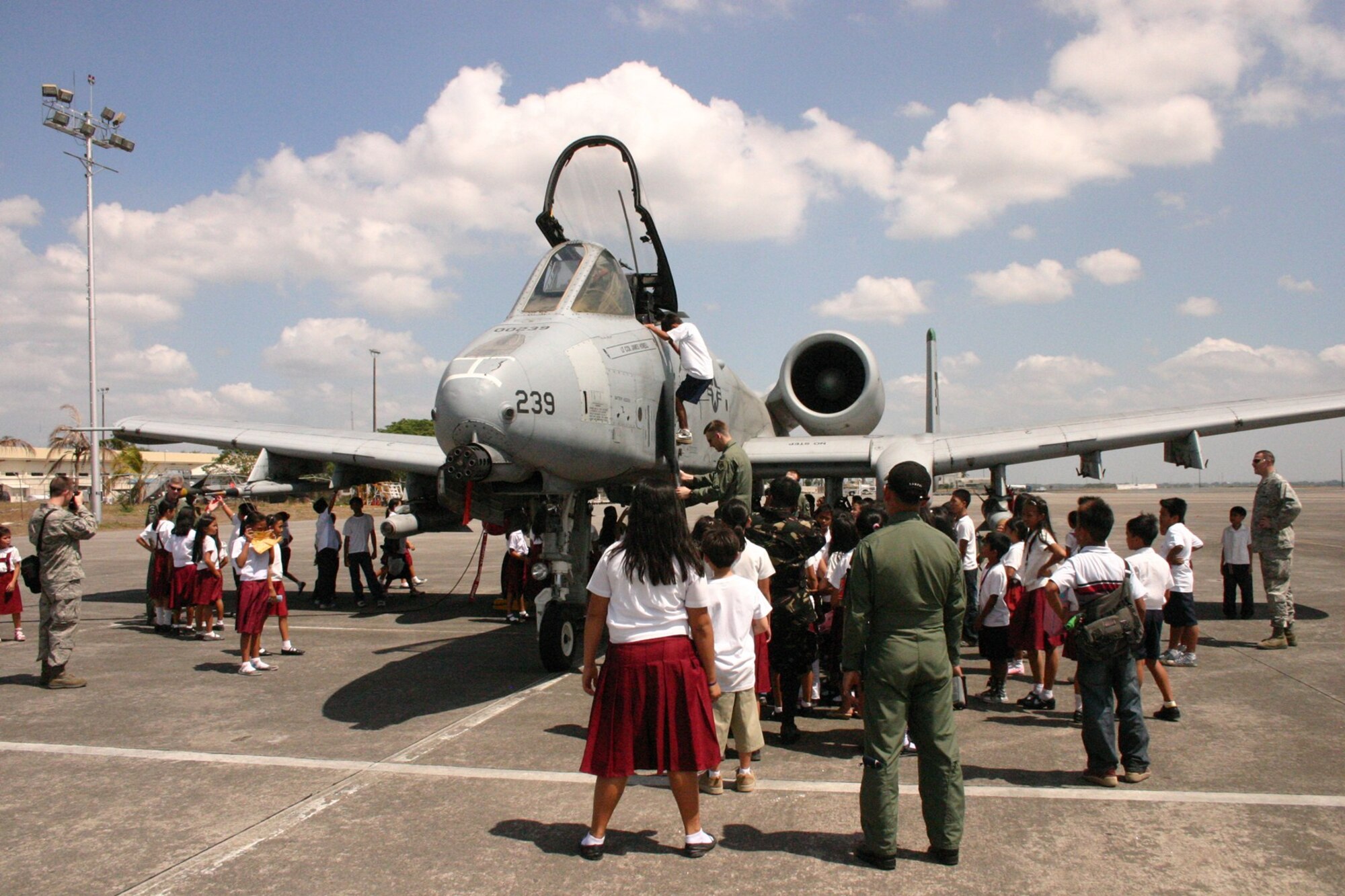 Philippine students view an A-10 Thunderbolt II at the Clark, Philippines, flight line March 15 during Balikatan 2010.  This was the first time many of the 300 students visiting the flight line had ever interacted with Armed Forces of the Philippines or U.S. servicemembers.  The visit was part of the Balikatan 2010 community outreach program. (U.S. Marine Corps photo/Gunnery Sgt. Cindy Fisher)