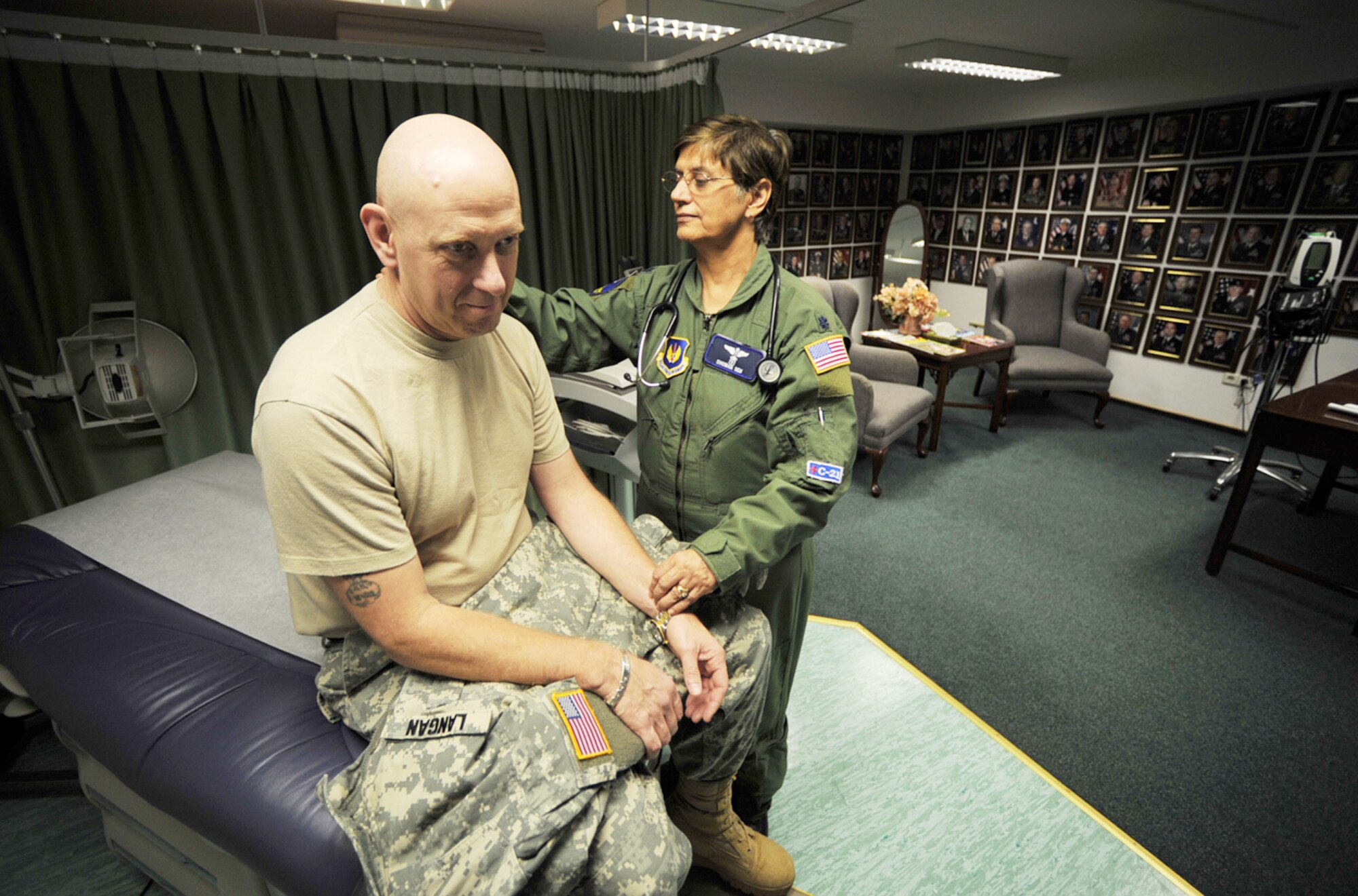 Army Col. William Langan gets a medical examination from Lt. Col. (Dr.) Shobha Sem during the U.S. European Command European Strategy Conference March 2, 2010, at Ramstein Air Base, Germany. Colonel Langan is assigned to the U.S. EUCOM Office of Defense Cooperation Cyprus and Doctor Sem is assigned to the 86th Medical Special Operations Clinc. (U.S. Air Force photo/Senior Airman Tony R. Ritter)
