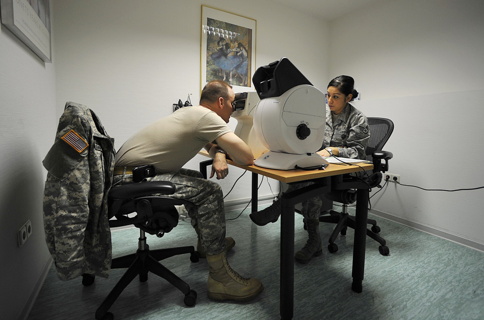 Army Lt.Col. Charles Davis gets an eye exam from Staff Sgt. Liliana Zamora during the U.S. European Command European Strategy Conference March 2, 2010, at Ramstein Air Base, Germany. Colonel Davis is assigned to the EUCOM Office of Defense Cooperation Croatia and Sergeant Zamora is a  medical technician with the 86th Medical Special Operations Clinic. (U.S. Air Force photo/Senior AIrman Tony R. Ritter)