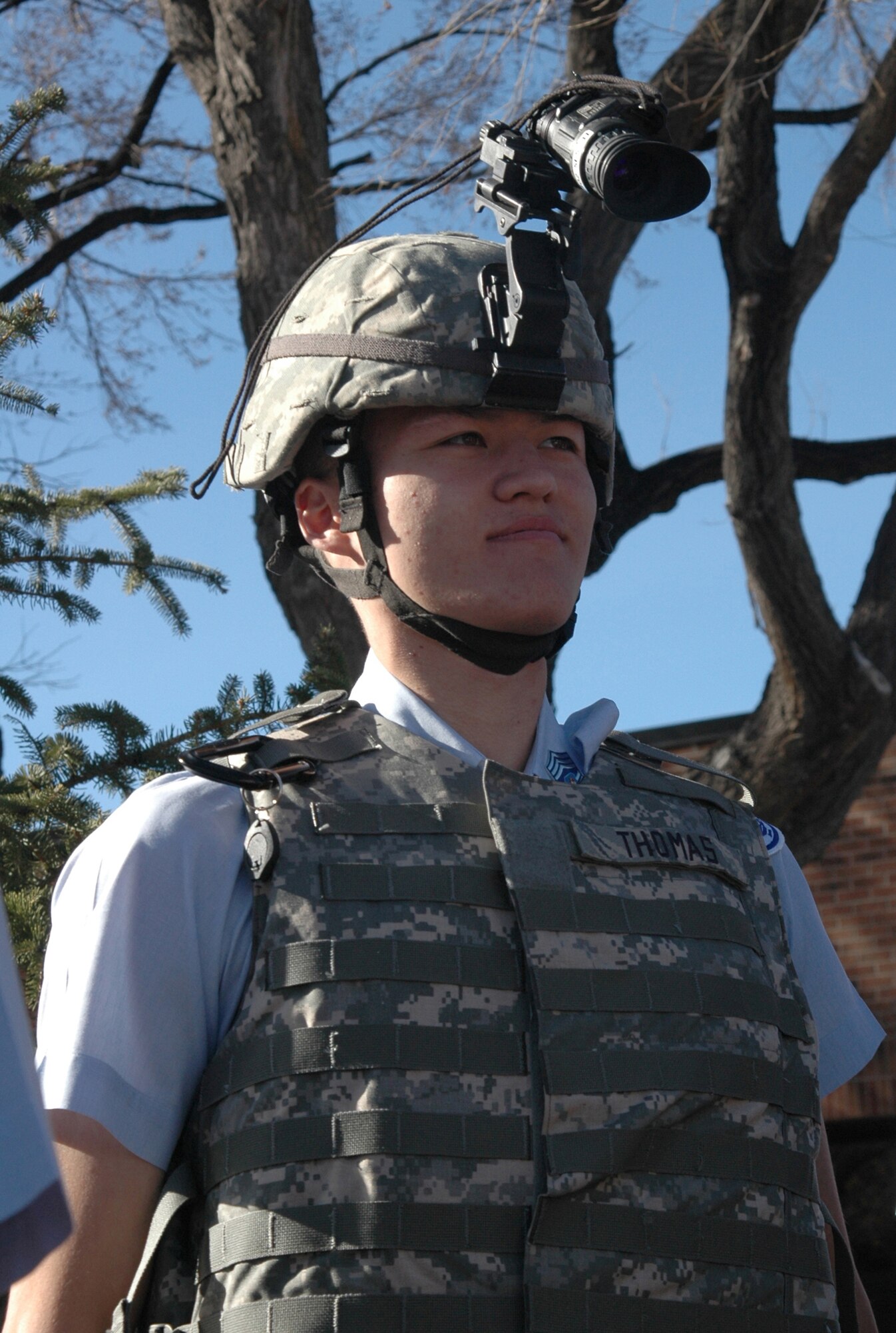 High school senior Merry Grayson, an Air Force Junior Reserve Officer Training Corps cadet from Colorado Springs, Colorado's Sand Creek High School, tries on a protective vest and night vision goggles March 17 during a security demonstration by the AF Reserve's 302nd Security Forces Squadron at Peterson Air Force Base, Colo. The JROTC member, together with more than 150 other cadets from around Colorado, toured Peterson and the AF Reserve's 302nd Airlift Wing, where they learned about unique jobs and opportunities with the AF Reserve. (U.S. Air Force photo/Tech. Sgt. Daniel Butterfield)
