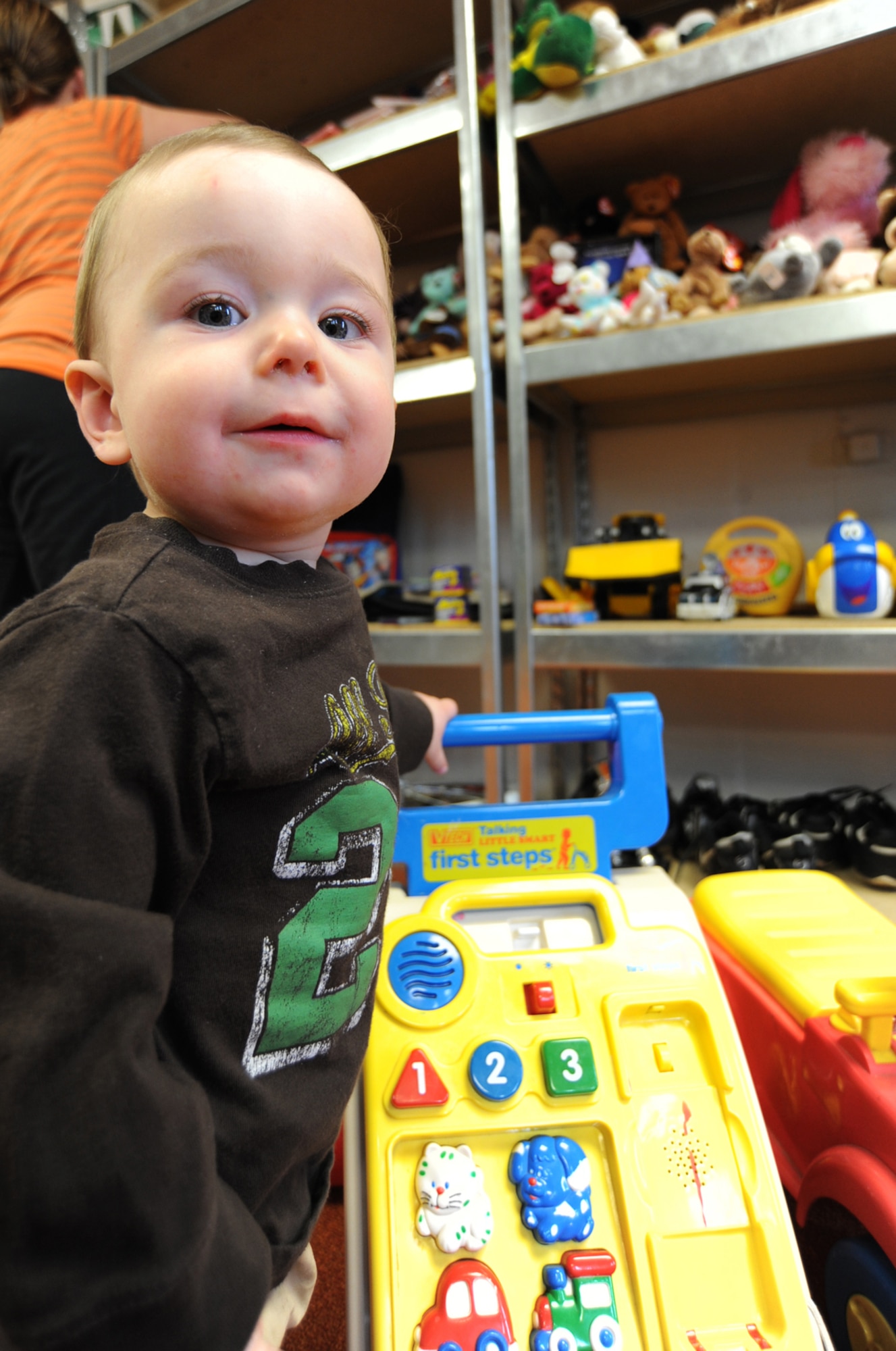 Michael Schneider, 1-year-old, plays with a toy while his mother, Gabby Schneider, views merchandise at the Airman’s Attic, March 12, 2010, McConnell Air Force Base, Kan. The Airman’s attic offers free appliances, clothes, children’s toys, baby items and other products for servicemembers E-5 and below. Hours of operation are Monday through Friday, 10 a.m. to 2 p.m. and donations are accepted at these times. (U.S. Air Force photo/Senior Airman Maria Ruiz)