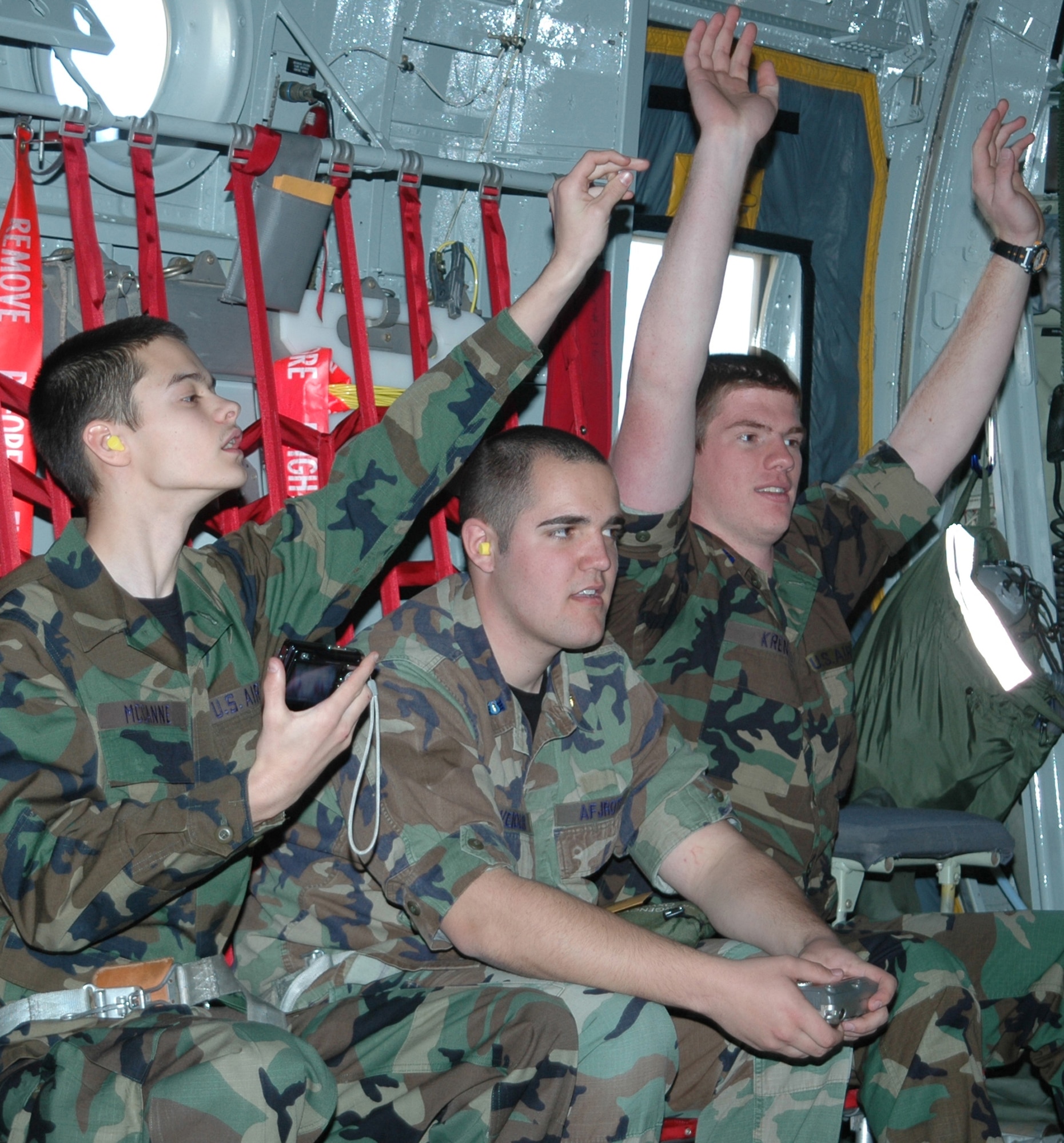 (Left to right): Air Force Junior Reserve Officer Training Corps cadets Matt McCanne, Mark Wiedler and Devon Kren, all Falcon High School students, enjoy a March 17 orientation flight aboard an AF Reserve C-130 Hercules aircraft. The three JROTC members toured Peterson Air Force Base and the 302nd Airlift Wing, along with JROTC cadets from six other Colorado schools, where they learned about unique jobs and opportunities with the AF Reserve. (U.S. Air Force photo/Tech. Sgt. Daniel Butterfield)