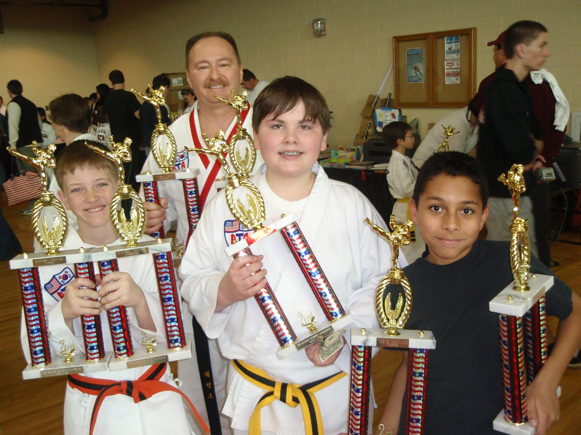 Members of the Peterson Taekwondo Club show off their trophies at the March 6, American Taekwondo Association regional tournament in Littleton, Colo. (From left) Michael Greene, Colby Tote, Tobias McMillan and (back) Klay Kerns are four of seven Peterson competitors. All seven placed in their individual events. (Courtesy photo)