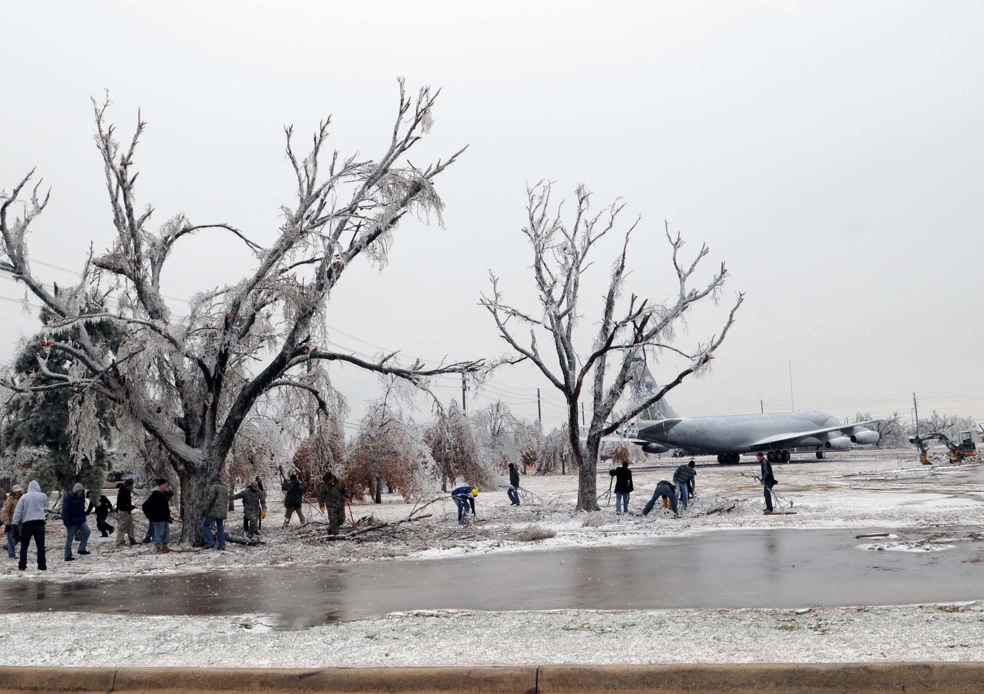 After an ice storm hit, volunteers work to clean up the fallen tree limbs Jan. 30, 2010 at the Wings of Freedom Park at Altus Air Force Base, Okla. (U.S. Air Force photo/Senior Airman Leandra D. Hernandez)