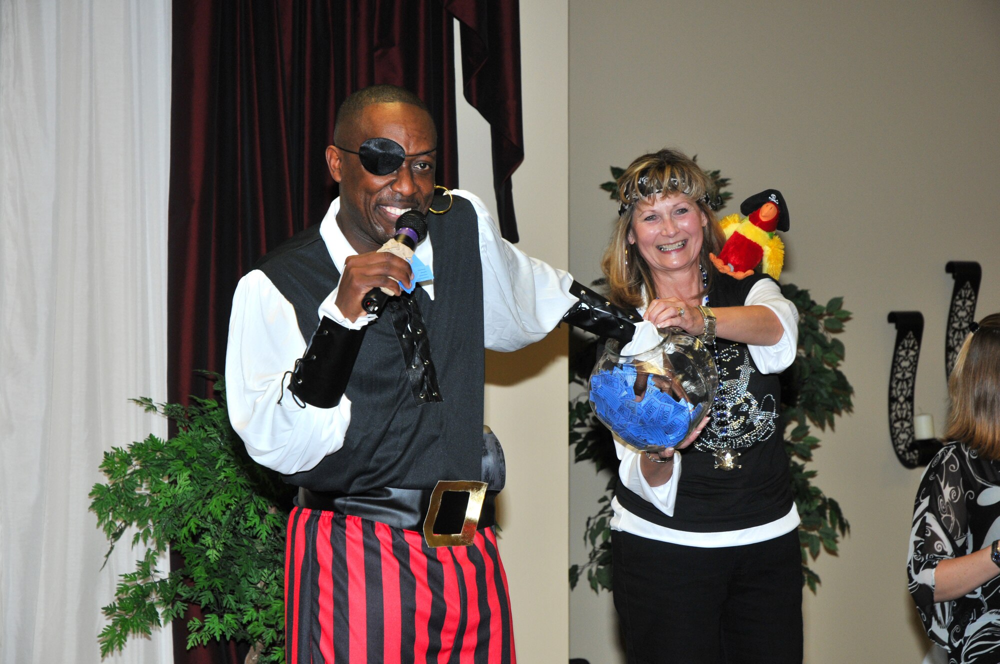 Master Sgt. Lee Wright, left, 333rd Training Squadron first sergeant, selects a winning door prize ticket from a bowl offered by Cheron Hollingsworth, first vice president of the KSC.  Her husband, Jim, is director of the training operations center at 2nd Air Force.  (U.S. Air Force photo by Adam Bond)
