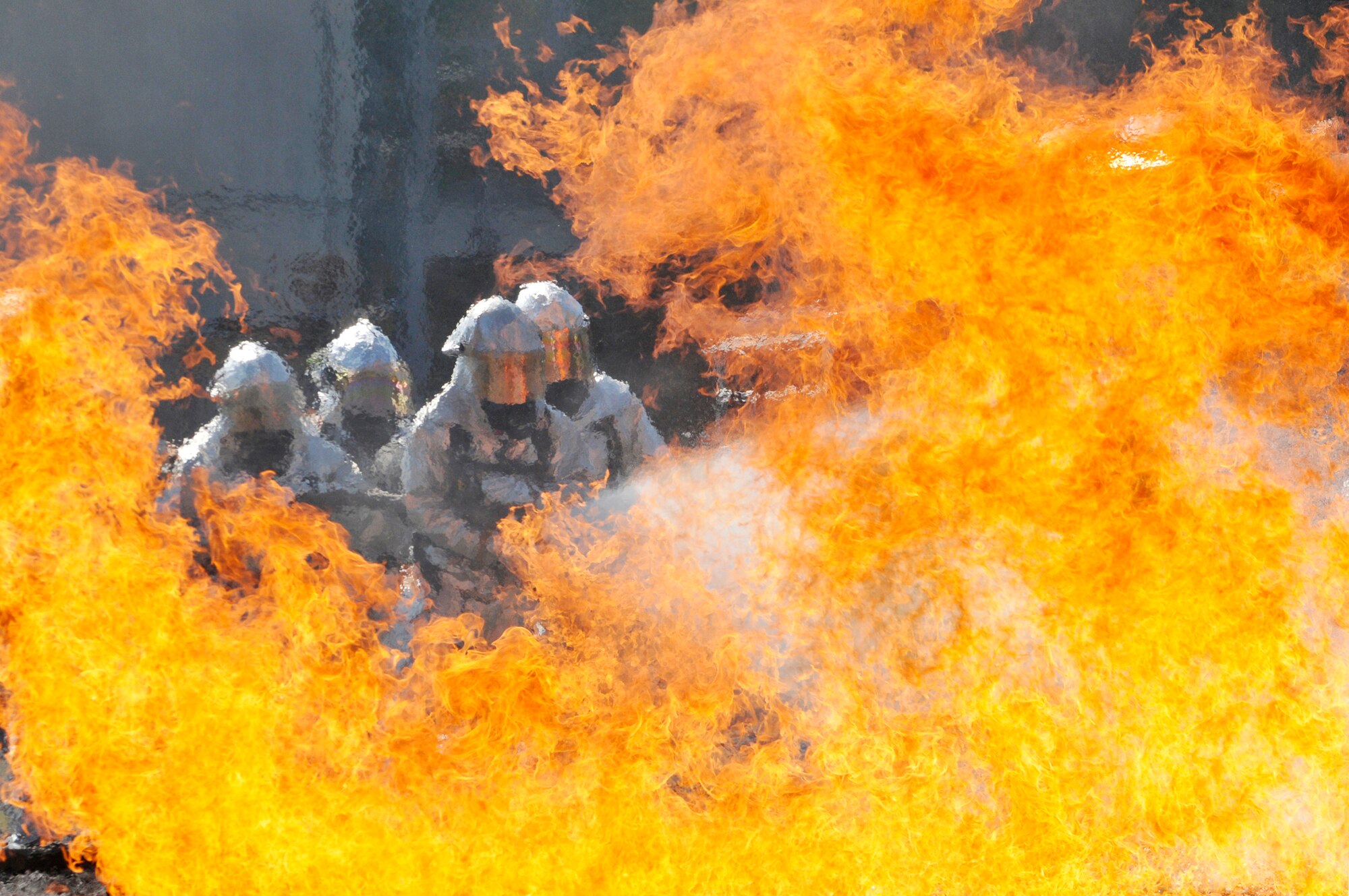 Firefighters from the 125th Fighter Wing at Jacksonville, Fla., and 71st Fighter Wing at Langley Air Force Base, Va, fight the fire in a burn pit at the Combat Readiness Training Center in Savannah, Ga., March 13, 2010. The burn pit re-creates most scenarios of a real aircraft fire. (U.S. Air Force photo/Tech. Sgt. Shelley Gill)