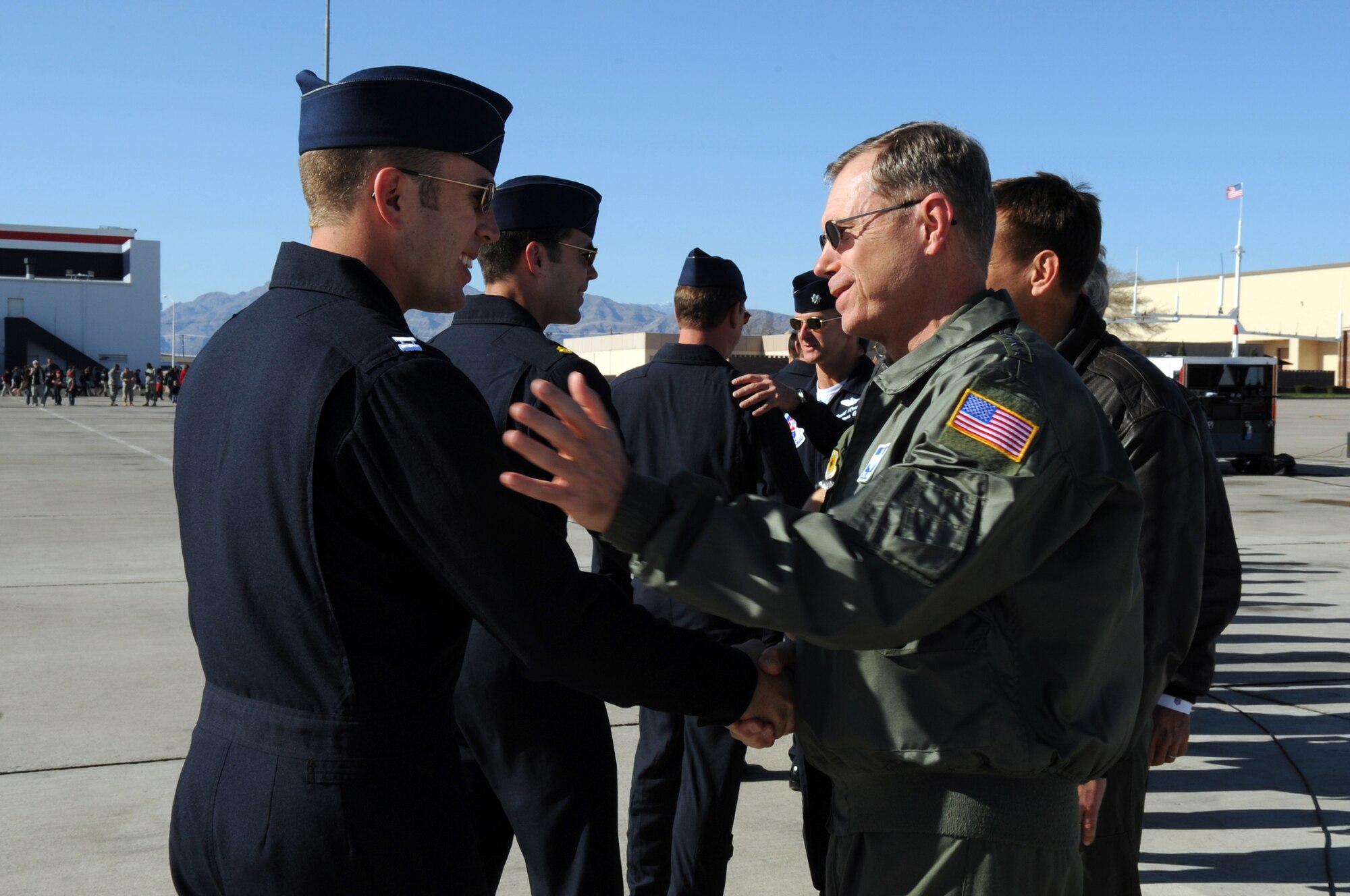 U.S. Air Force Gen. William M. Fraser III, commander, Air Combat Command, greets Capt. Paul Jelinek, U.S. Air Force Air Demonstration Squadron "Thunderbirds" opposing solo pilot, following the team's acceptance show at Nellis Air Force Base, Nev., March 11.  Stationed at Nellis AFB in Las Vegas since 1956, the Thunderbirds are preparing for the team's 57th season, which will take them to more than 65 shows in 27 states and Canada. (U.S. Air Force photo by Staff Sgt. Richard Rose)