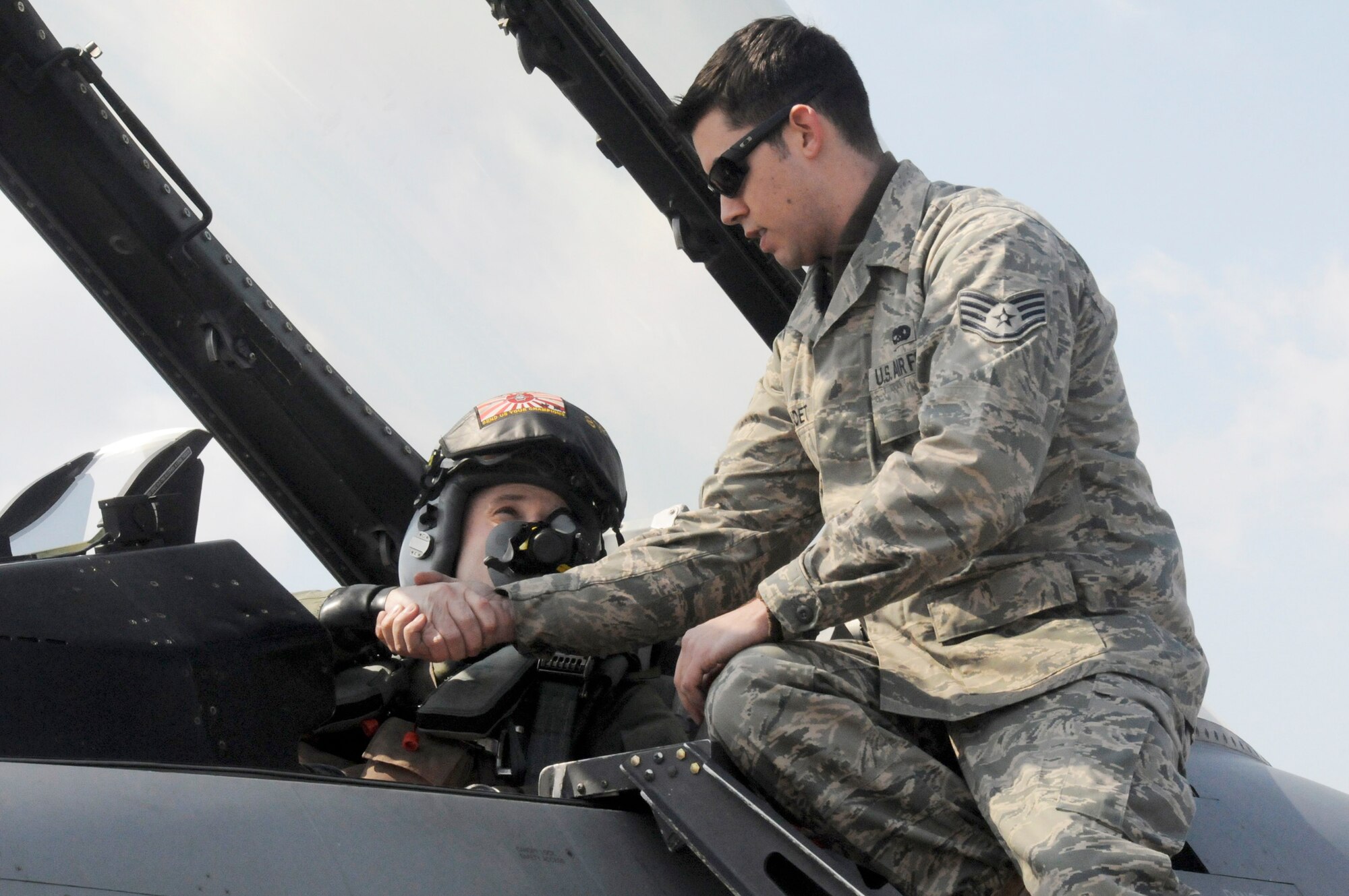Staff Sgt. Christopher Audet shakes hands with Capt. Matt Kenkel, prior to takeoff March 11, 2010, at Tsuiki Air Base, Japan. Sergeant Audet is a 35th Maintenance Squadron crewchief. Captain Kenkel is a 14th Fighter Squadron pilot. (U.S. Air Force photo/Staff Sgt. Rachel Martinez)