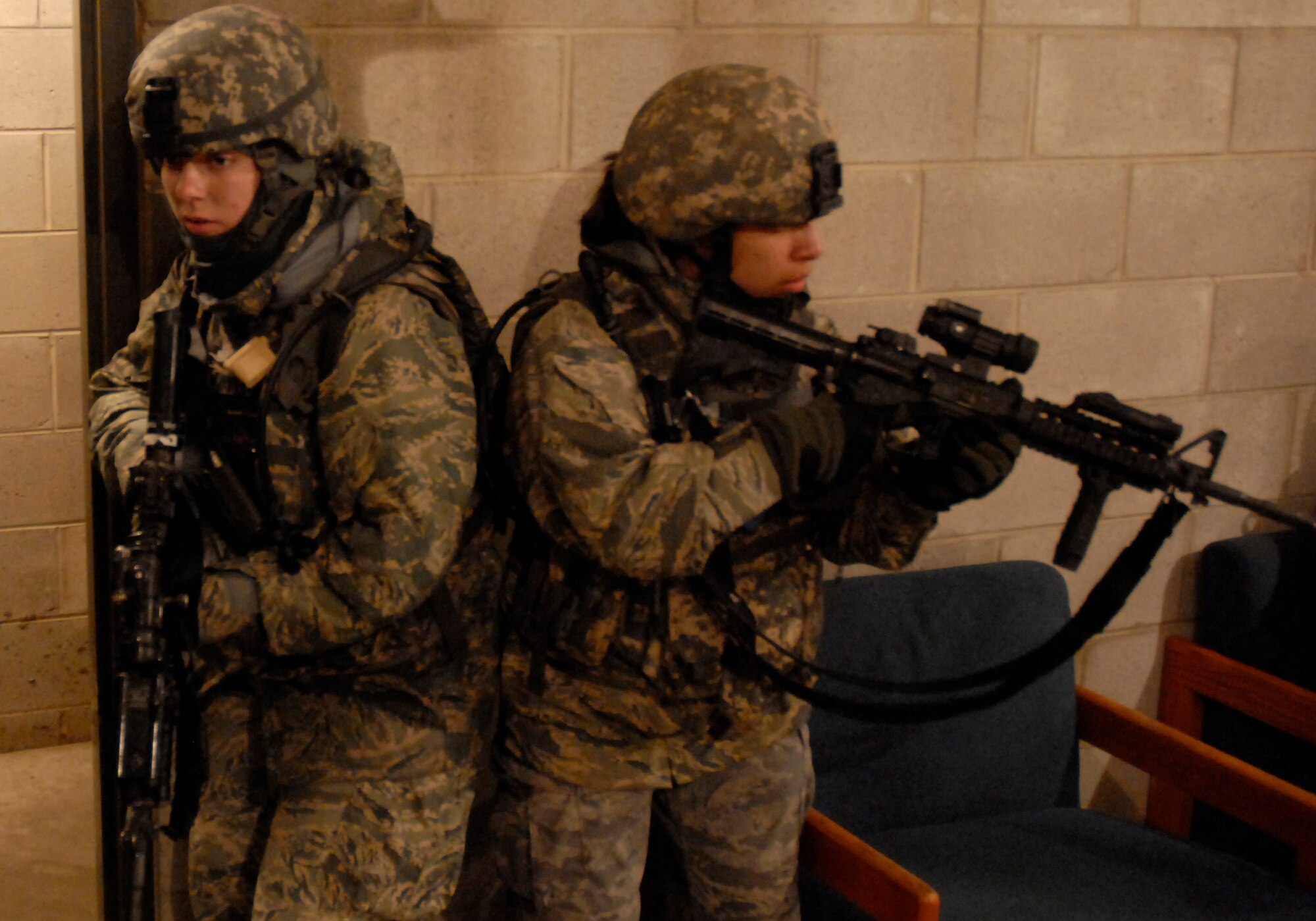 Senoir Airmen Jenelle Christian and Yesenia Luna from the 7th Security Forces Squadron, Dyess AFB, Texas stack up to prepare for a room entry during urban operations training as part of their pre-deployment training hosted by the U.S. Air Force Expeditionary Center, Joint Base McGuire-Dix-Lakehurst, N.J. March 13, 2010. The training is conducted by the 421st Combat Training Squadron. (U.S. Air Force Photo/Tech. Sgt. Paul R. Evans)