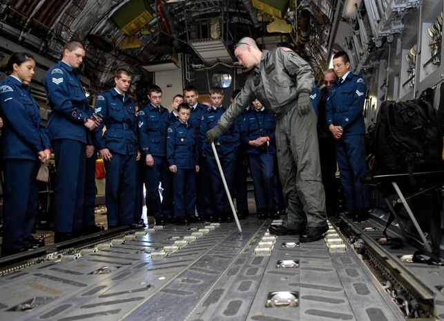 Royal Canadian Air Force cadets look on as U.S. Air Force Senior Airman Ken Connor demonstrates the modifiable capabilities of the C-17 cargo bay at Joint Base Charleston, S.C., March 16, 2010. The cadets drove 22 hours from London, Ontario, Canada, to learn about American military operations. During their tour of Joint Base Charleston, the cadets toured numerous base facilities and watched a demonstration of the military working dogs. Airman Connor is a load master with the 16th Airlift Squadron. (U.S. Air Force Photo/Airman 1st Class Lauren Main)