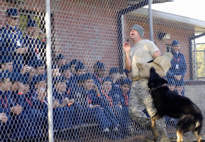 Royal Canadian Air Force Cadets look on as U.S. Air Force Staff Sgt. Brandon Serena and military working dog, Waldo, perform a working dog demonstration on Joint Base Charleston, S.C., March 16, 2010. The demonstration consisted of numerous scenarios, all of which ended with Waldo's teeth locking onto Sergeant Serena's protected arm. Throughout their one-day tour of Joint Base Charleston, the cadets toured multiple squadrons and a static C-17. Sergeant Serena is a military working dog handler with the 628th Security Forces Squadron. (U.S. Air Force photo/Airman 1st Class Lauren Main)