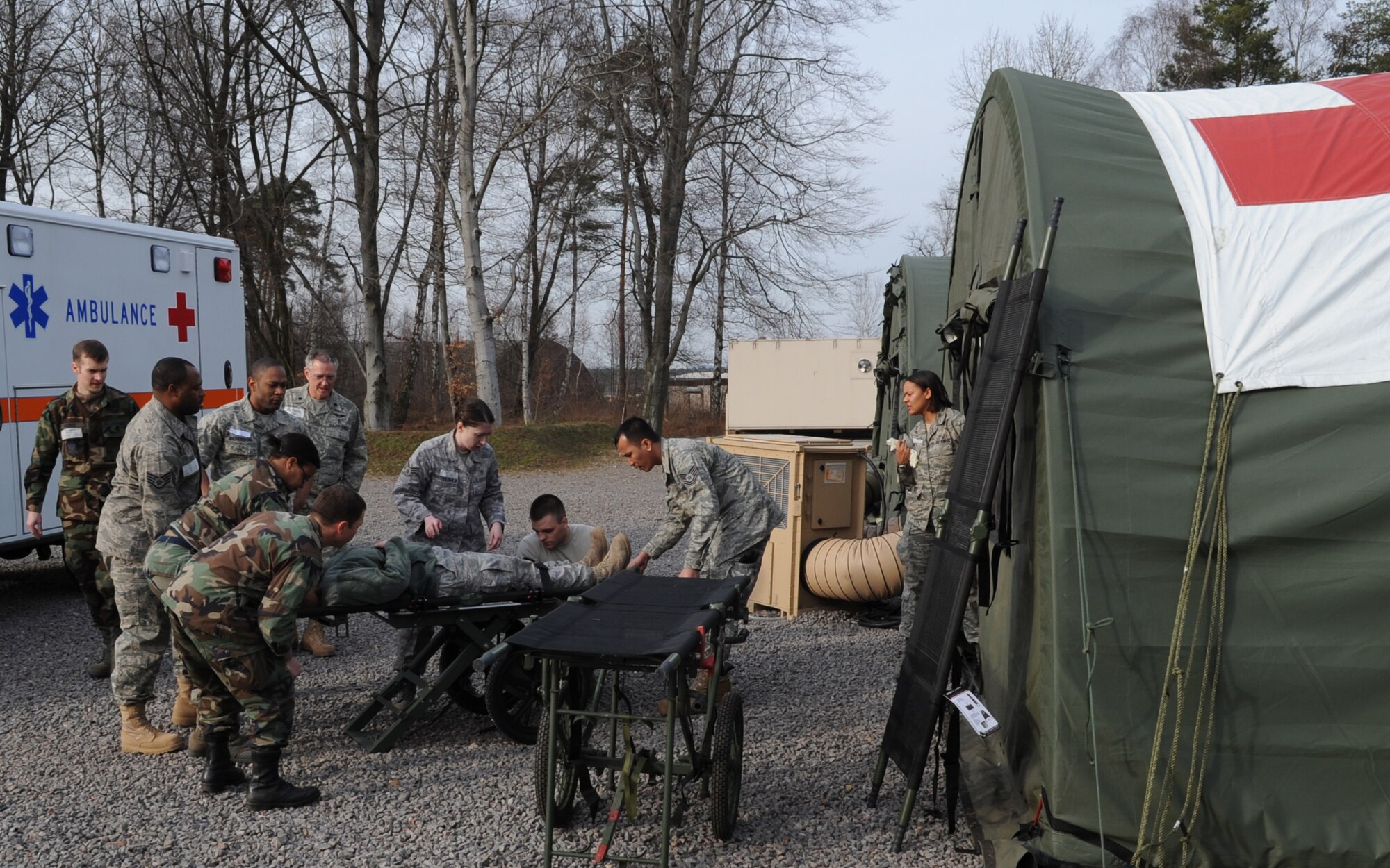 U.S. Air Force medical members participate in a mass casualty exercise during the Expeditionary Medical Support (EMEDS) Mobile Course training, Ramstein Air Base, Germany, March 17, 2010. The EMEDS course teaches and evaluates corps specific field situations as well as offers updates in Air Force Medical Service concept of operations and doctrine. It also teaches setup and packing out of a field EMEDS compound, deployed operations, field medical, nursing and operational support equipment proficiency, field exercises to both emphasize and evaluate learning of concepts taught. (U.S. Air Force photo by Airman 1st Class Caleb Pierce)