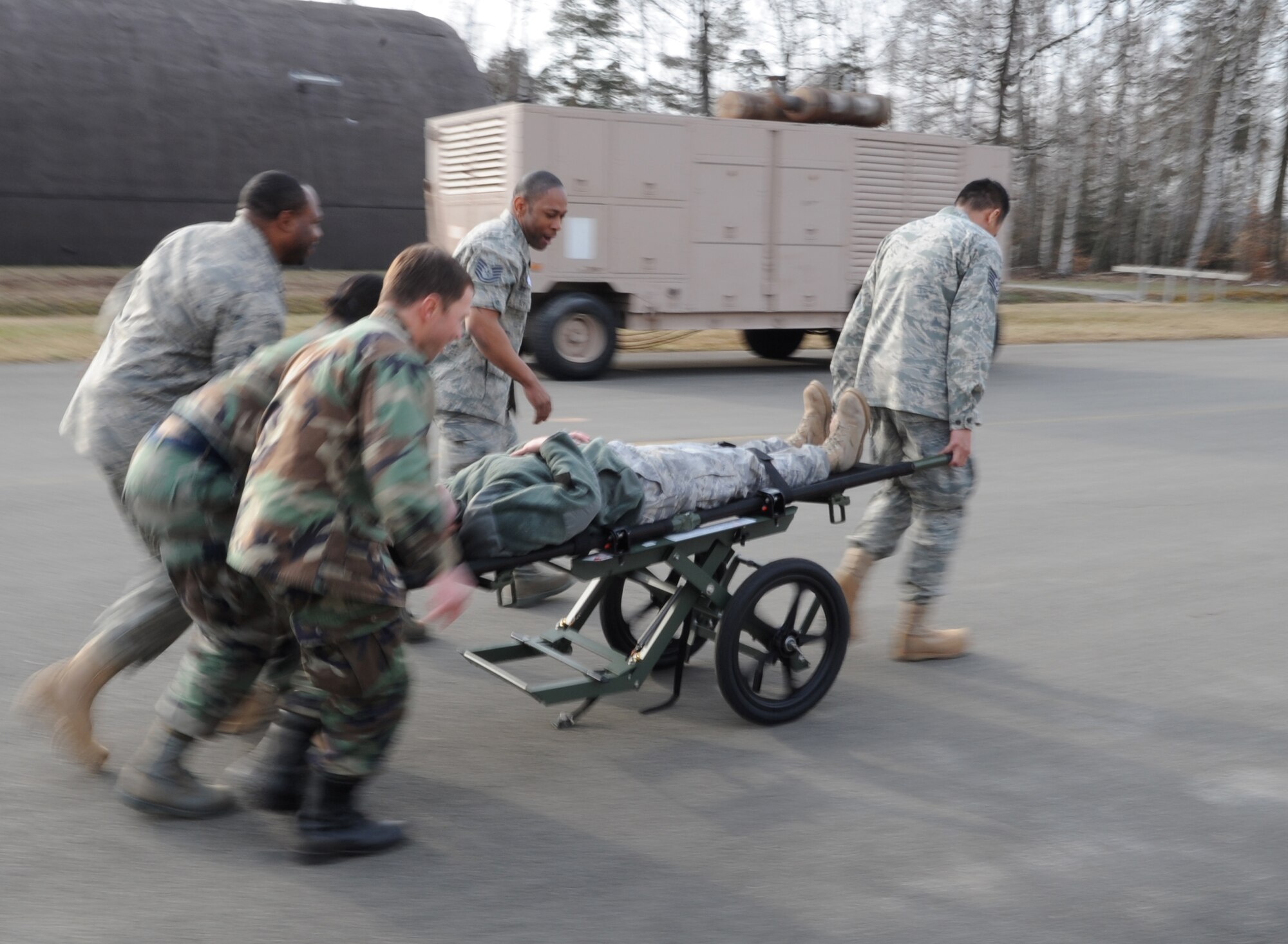 U.S. Air Force medical members participate in a mass casualty exercise during the Expeditionary Medical Support (EMEDS) Mobile Course training, Ramstein Air Base, Germany, March 17, 2010. The EMEDS course teaches and evaluates corps specific field situations as well as offers updates in Air Force Medical Service concept of operations and doctrine. It also teaches setup and packing out of a field EMEDS compound, deployed operations, field medical, nursing and operational support equipment proficiency, field exercises to both emphasize and evaluate learning of concepts taught. (U.S. Air Force photo by Airman 1st Class Caleb Pierce)
