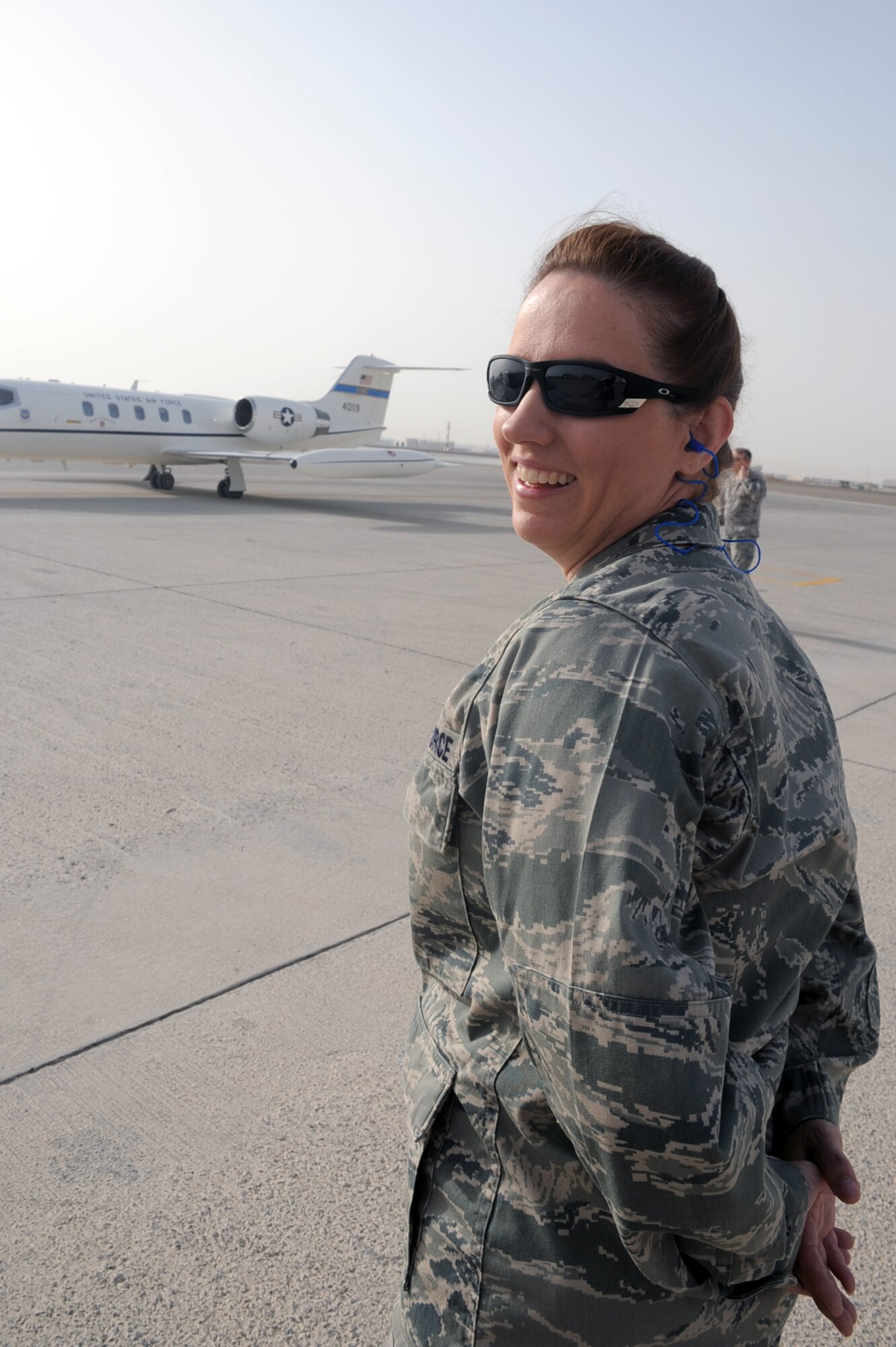 Capt. Sandra Byrum, 380th Air Expeditionary Wing protocol officer, talks over the radio works during a visit to the 380th AEW by a distinguished visitor at a non-disclosed base in Southwest Asia on Feb. 10, 2010. Captain Byrum is deployed from Joint Base McGuire-Dix-Lakehurst, N.J., and her hometown is Rainsville, Ala.  (U.S. Air Force Photo/Master Sgt. Scott T. Sturkol/Released)