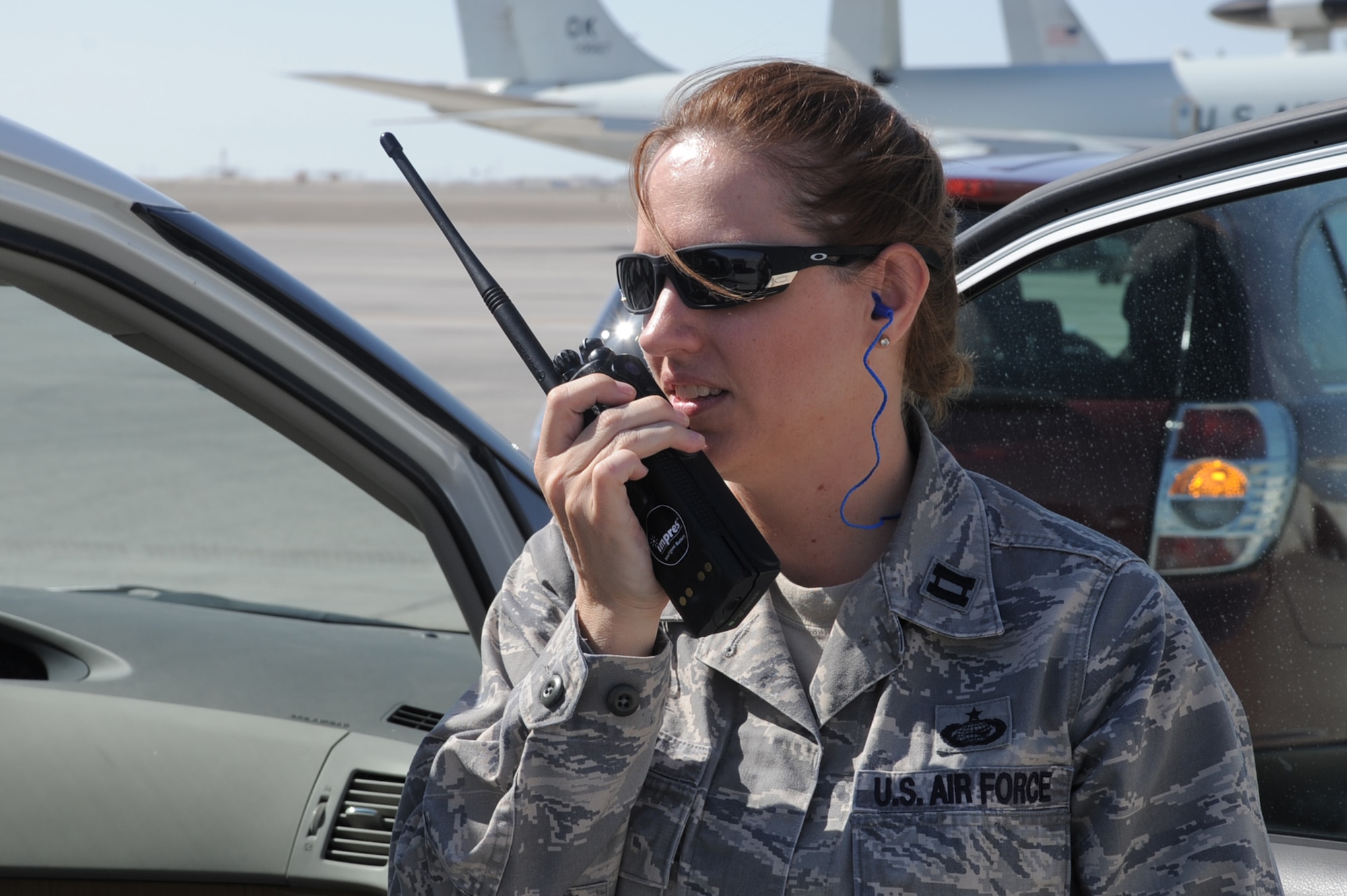 Capt. Sandra Byrum, 380th Air Expeditionary Wing protocol officer, talks over the radio while coordinating a visit to the 380th AEW by a distinguished visitor at a non-disclosed base in Southwest Asia on Feb. 10, 2010. Captain Byrum is deployed from Joint Base McGuire-Dix-Lakehurst, N.J., and her hometown is Rainsville, Ala.  (U.S. Air Force Photo/Master Sgt. Scott T. Sturkol/Released)