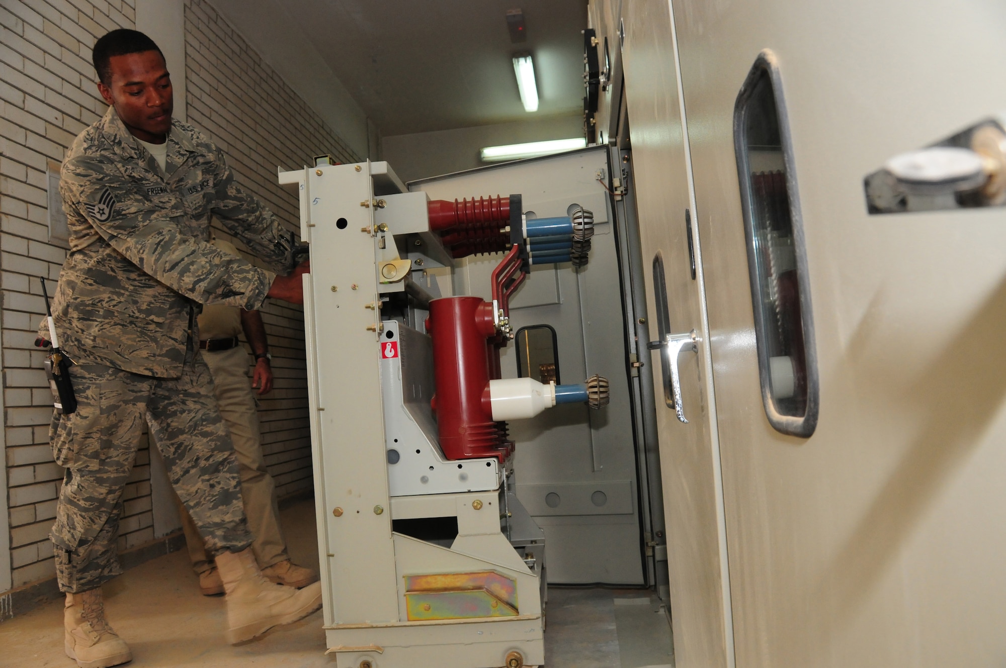 U.S. Air Force Staff Sgt. Joshua Freeman, 386th Expeditionary Civil Engineer Squadron electrician, follows established lockout safety procedures and "racks out" a primary high voltage circuit breaker, physically disconnecting the 11,500 volt power source so the circuit breakers and secondary side equipment can be safely serviced March 12, 2010 at an air base in Southwest Asia. Sergeant Freeman is deployed from the 137th Air Refueling Wing at Will Rogers Air National Guard Base, Okla. (U.S. Air Force photo by Staff Sgt. Lakisha A. Croley/Released)
