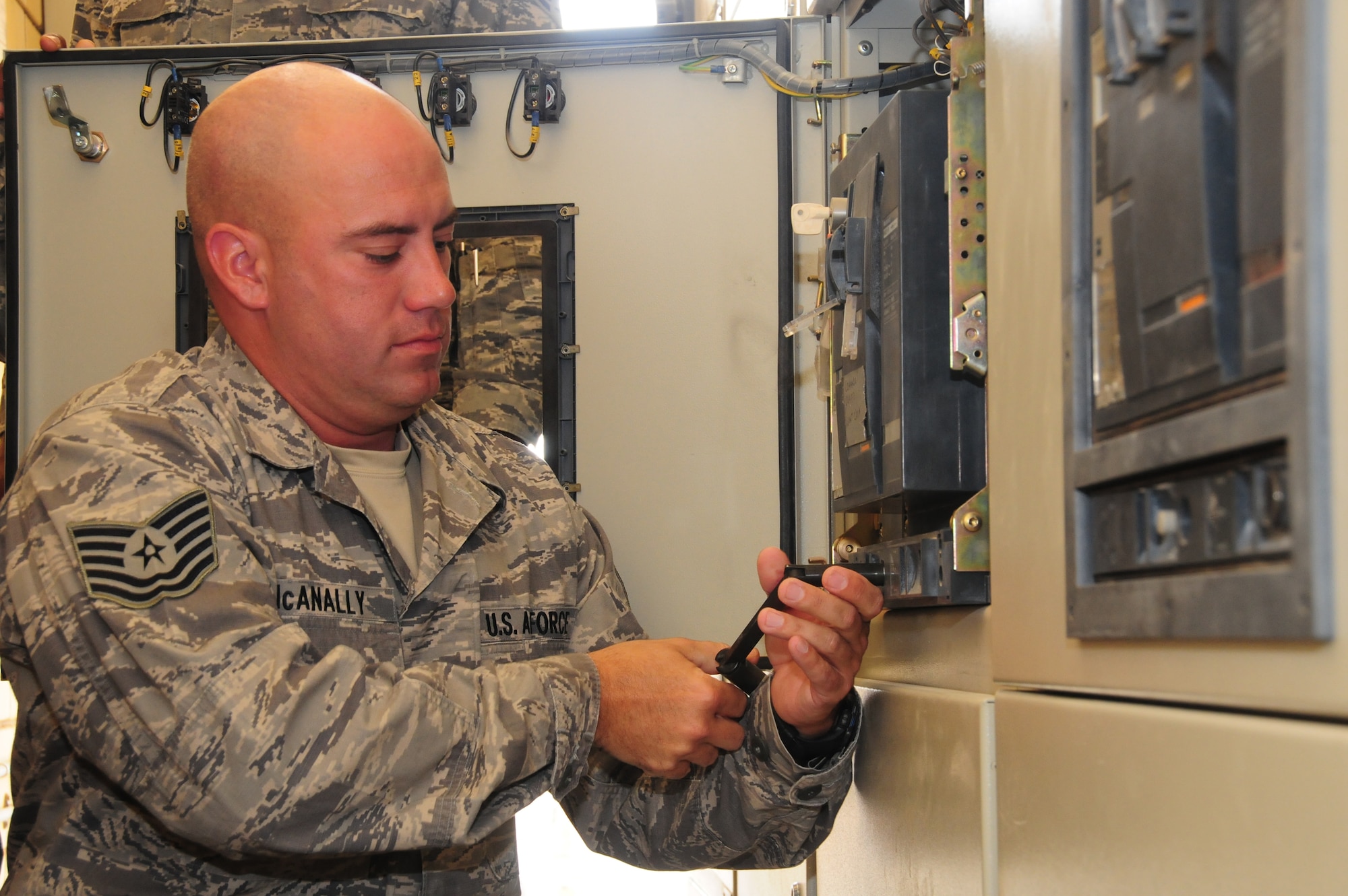 U.S. Air Force Tech. Sgt. Jimmy McAnally, 386th Expeditionary Civil Engineer Squadron electrician, follows safety lockout procedures and "racks out" a 400 amp circuit breaker from a de-energized 415 volt secondary line switchgear to perform troubleshooting and maintenance March 12, 2010 at an air base in Southwest Asia. Sergeant McAnally is deployed from the 137th Air Refueling Wing at Will Rogers Air National Guard Base, Okla. (U.S. Air Force photo by Staff Sgt. Lakisha A. Croley/Released)