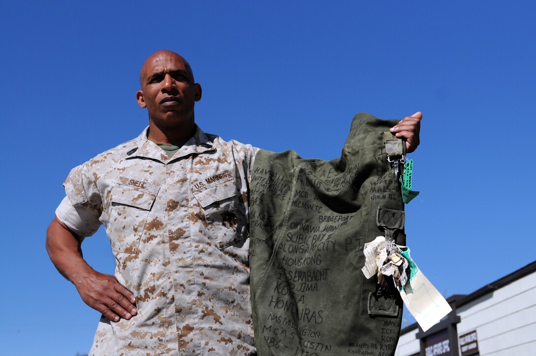 Master Sgt. Michael B. Snell, Marine Attack Squadron 214 maintenance chief, displays the sea bag he received in boot camp, on which he wrote down all the places he’s seen and units he’s been a part of throughout his 23-year-old military career in 2010. The bag has more than 30 locations from 20 countries around the world, some with Roman numerals to reflect multiple visits. VMA-214 is stationed at the Marine Corps Air Station in Yuma, Ariz.