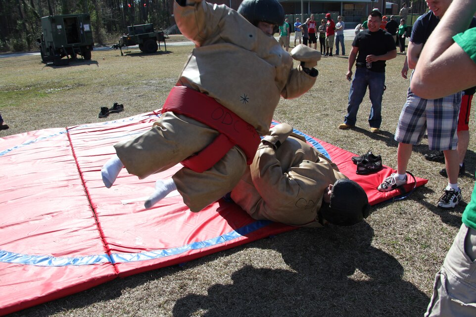 A pair of Marine Air Control Squadron 2 Marines bring some acrobatics sumo wrestling during the family day event held at MACS-2’s parade field, March 19. MACS-2 Marines and their family members enjoyed the day competing in different events, as well as learning about equipment MACS-2 uses.