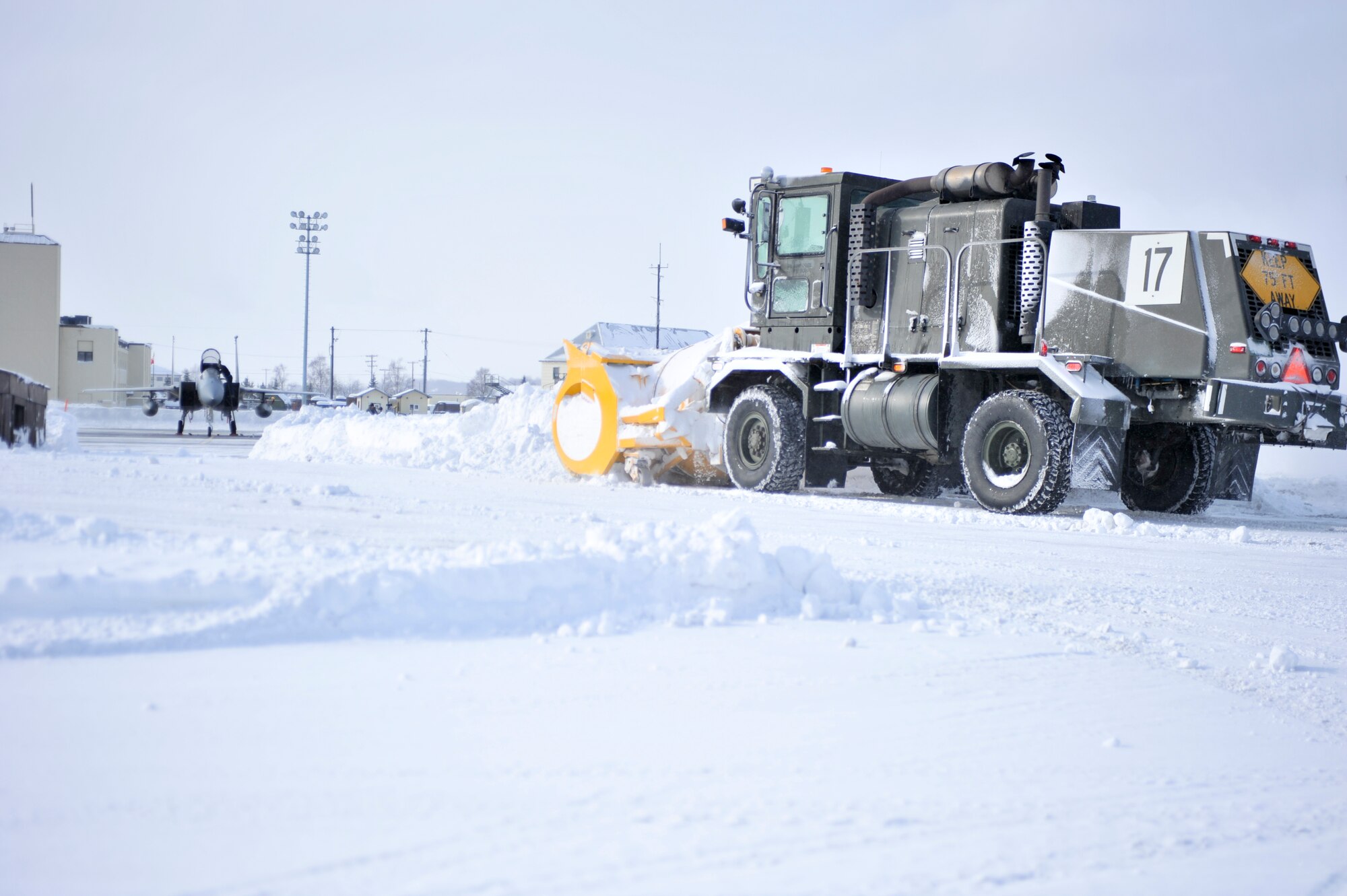 ELMENDORF AIR FORCE BASE, Alaska – A member of the 3rd Civil Engineer Squadron drives a snow blower on the flightline March 10 to clear a taxi way for an F-15. (U.S. Air Force photo/ Airman 1st Class Jack Sanders)